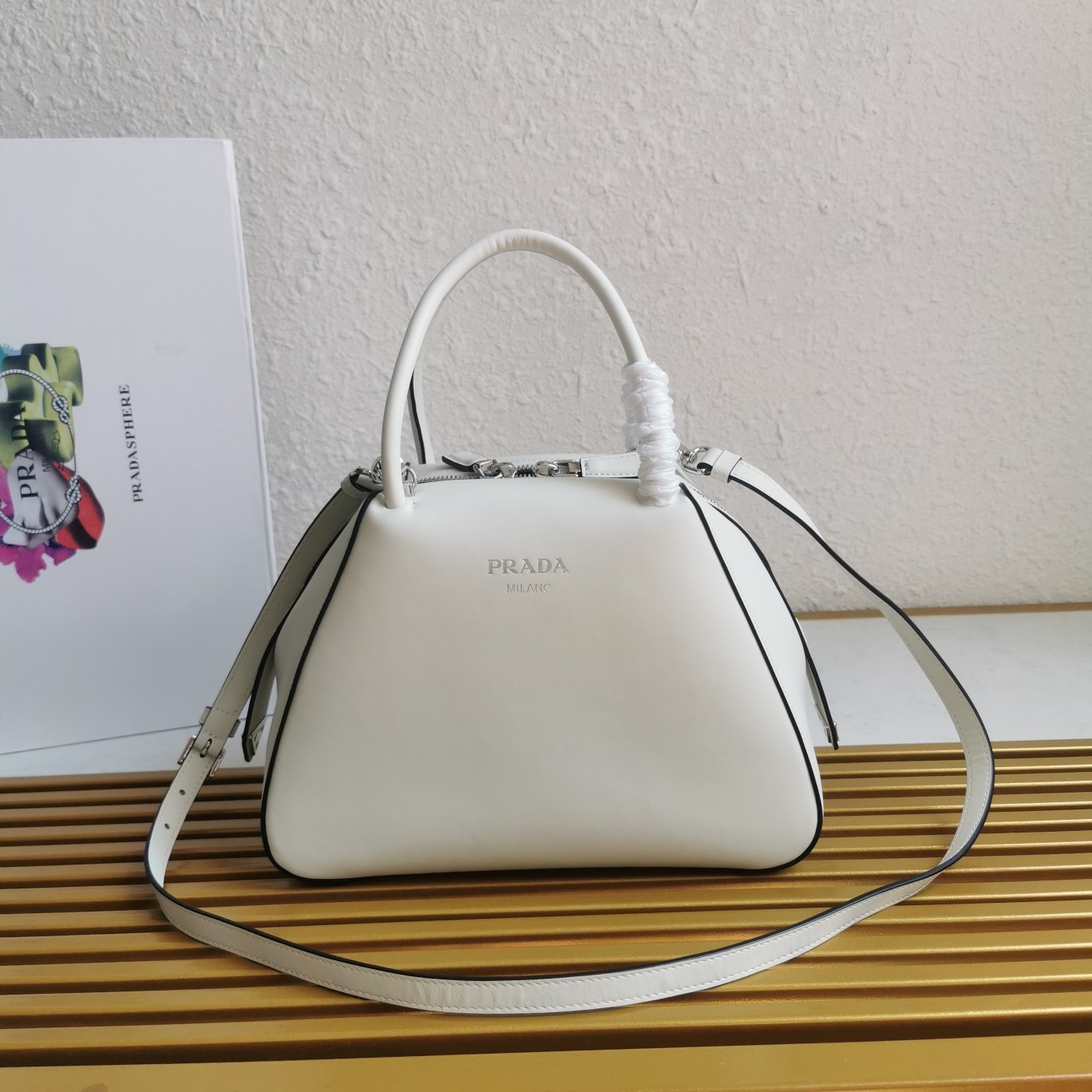 pra*a S*pernova small handbag in white leather
