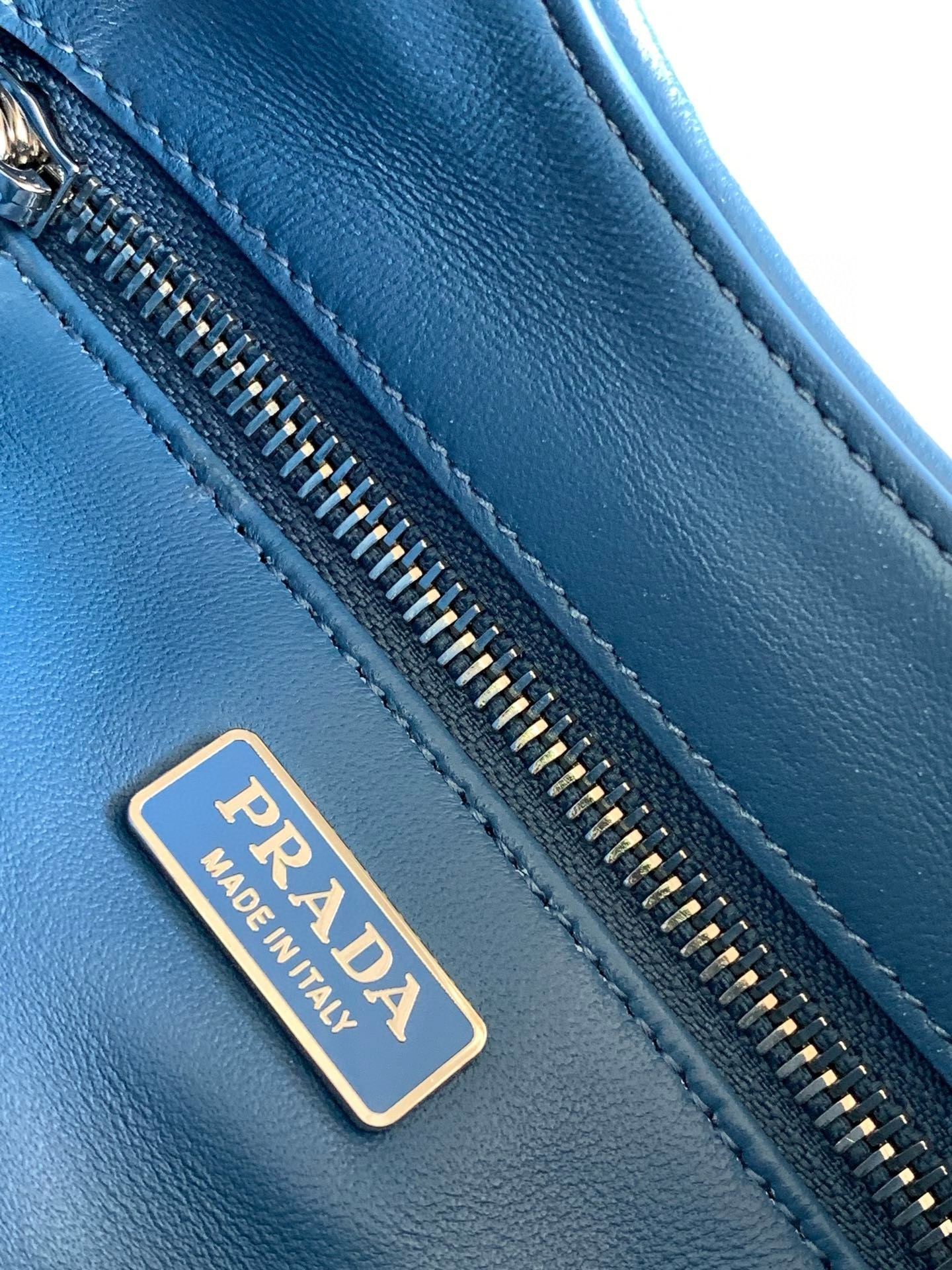 Pra*a moon bag in blue padded nappa leather
