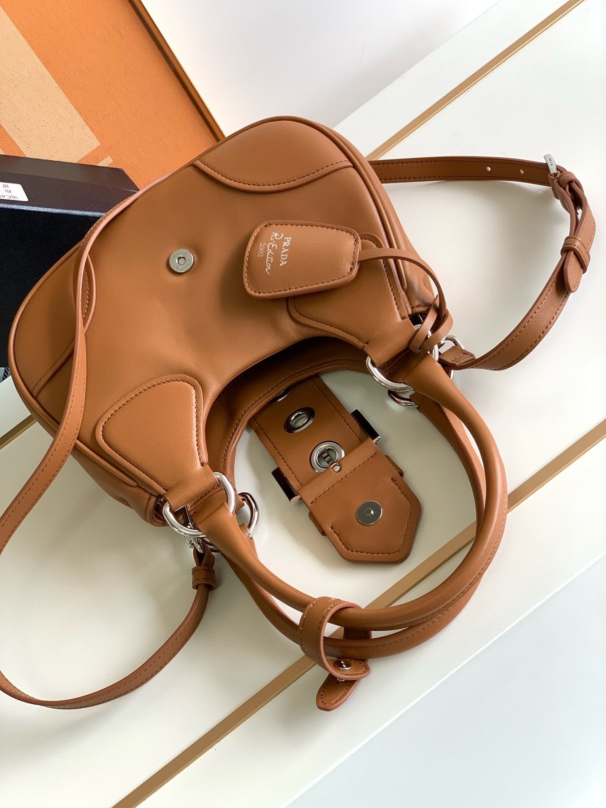 Pra*a moon bag in caramel padded nappa leather