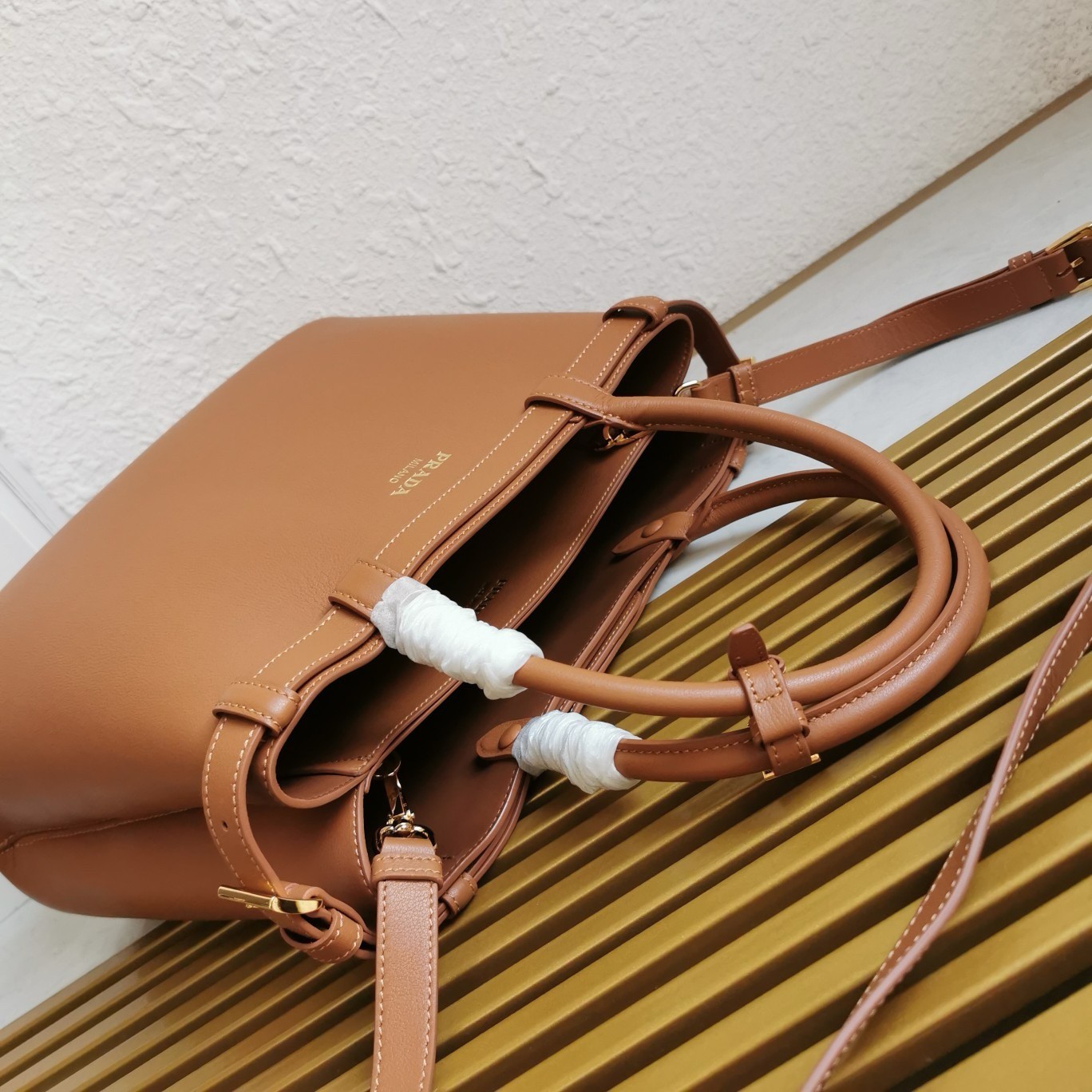 Pra*a buckle medium bag with double belt in brown leather