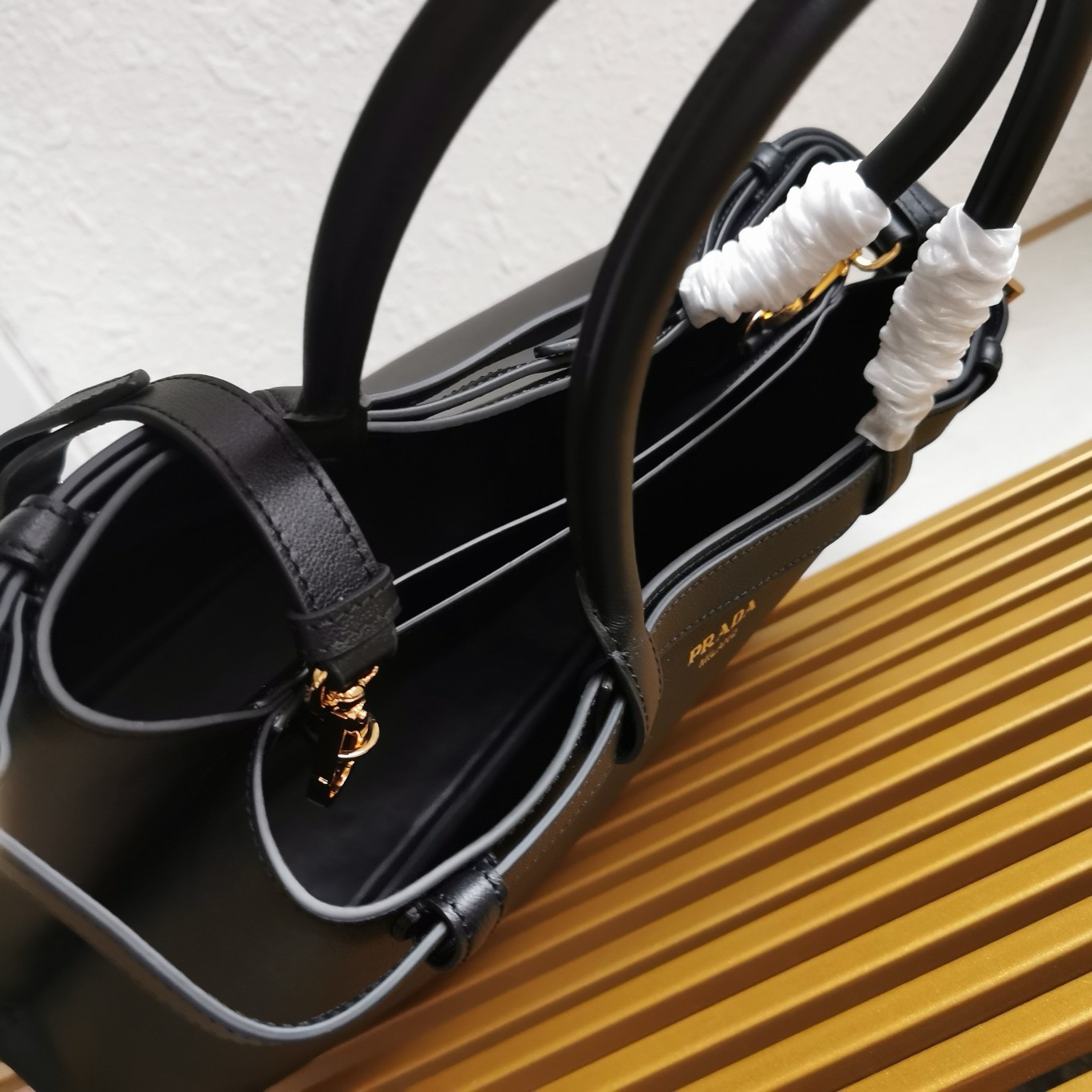 Pra*a buckle medium bag with double belt in black leather