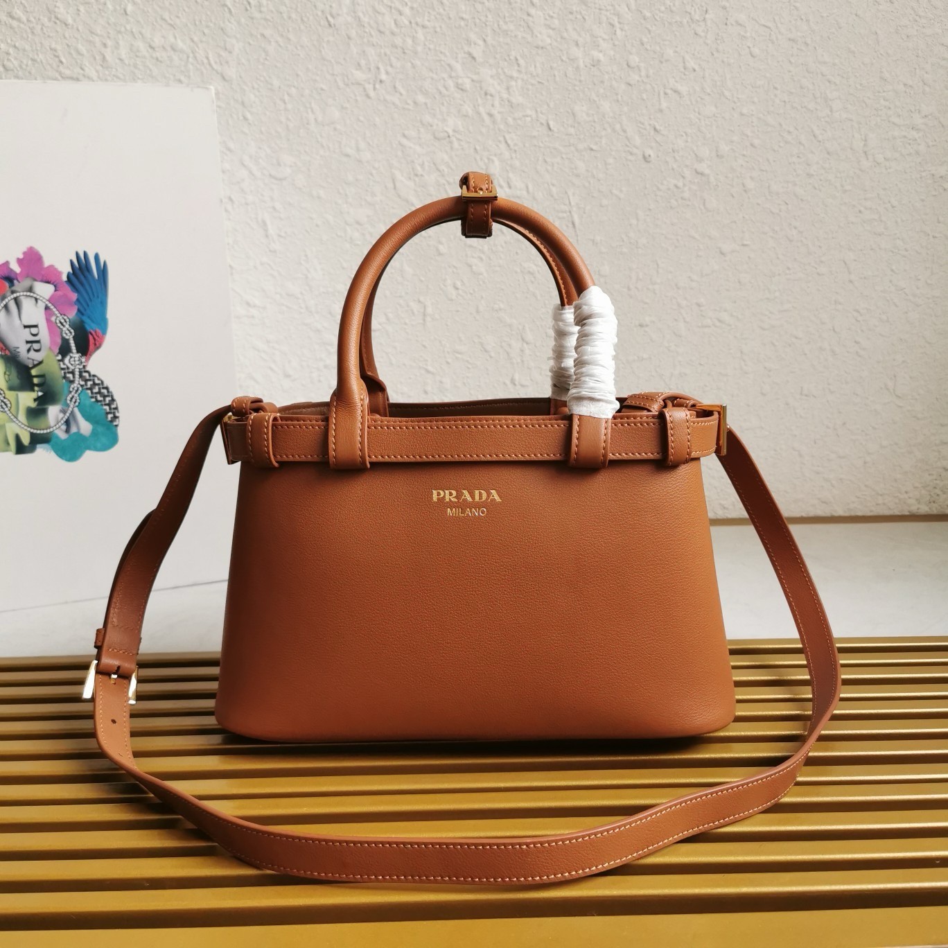 Pra*a buckle small bag with double belt in brown leather