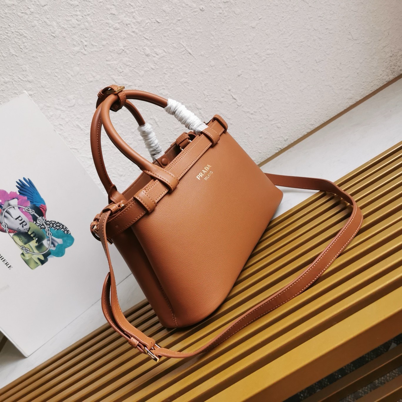 Pra*a buckle small bag with double belt in brown leather