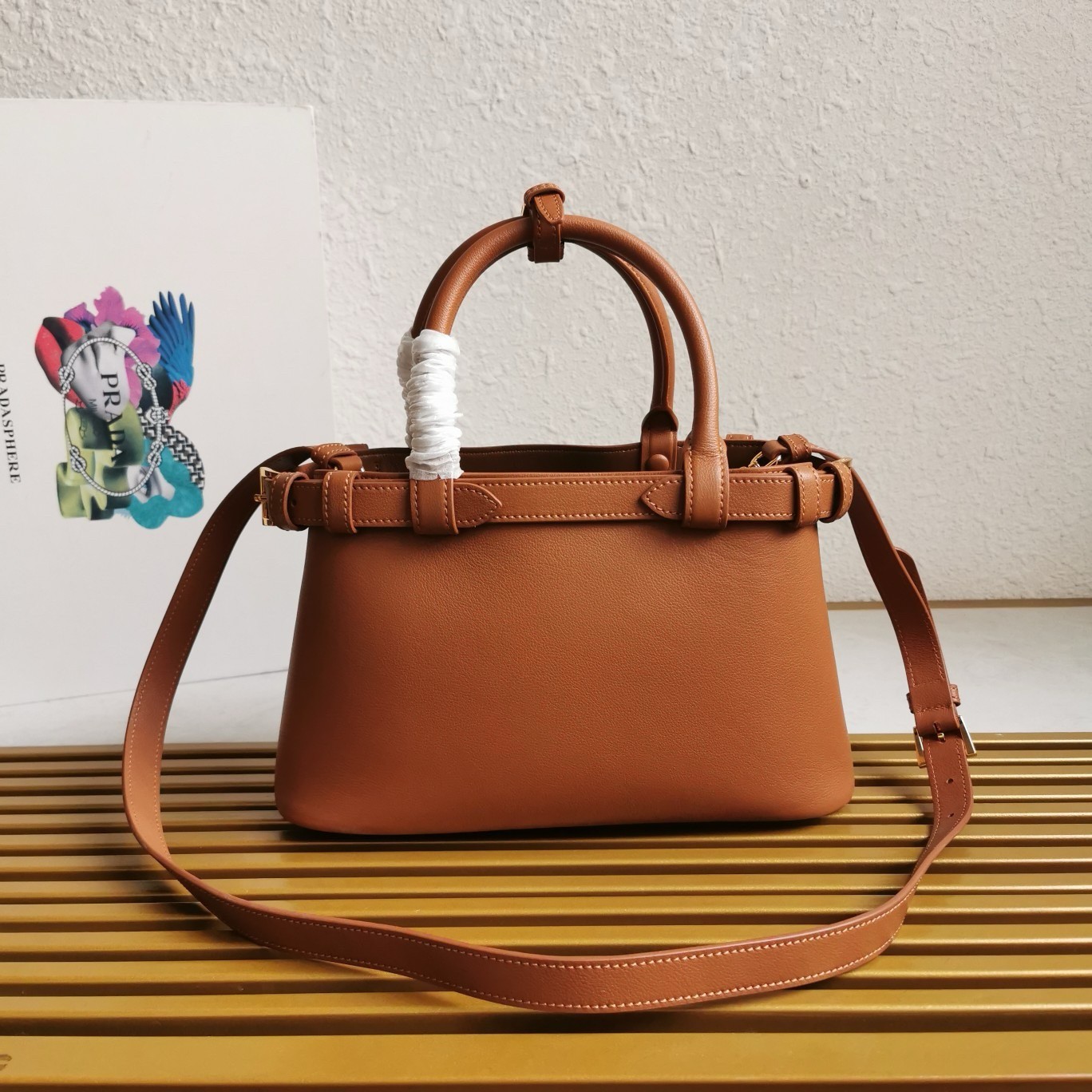 Pra*a buckle small bag with double belt in brown leather