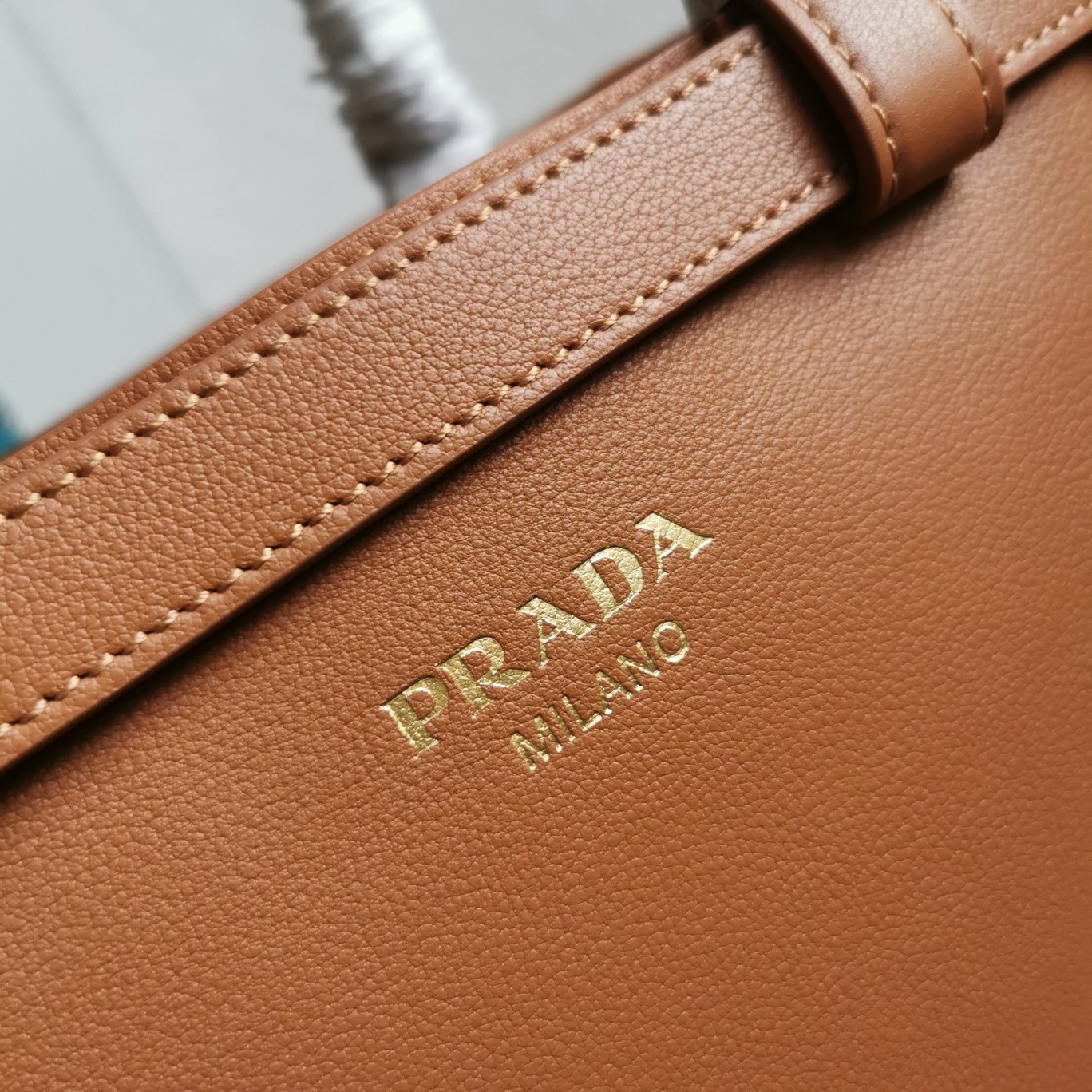 Pra*a buckle small bag with double belt in brown leather