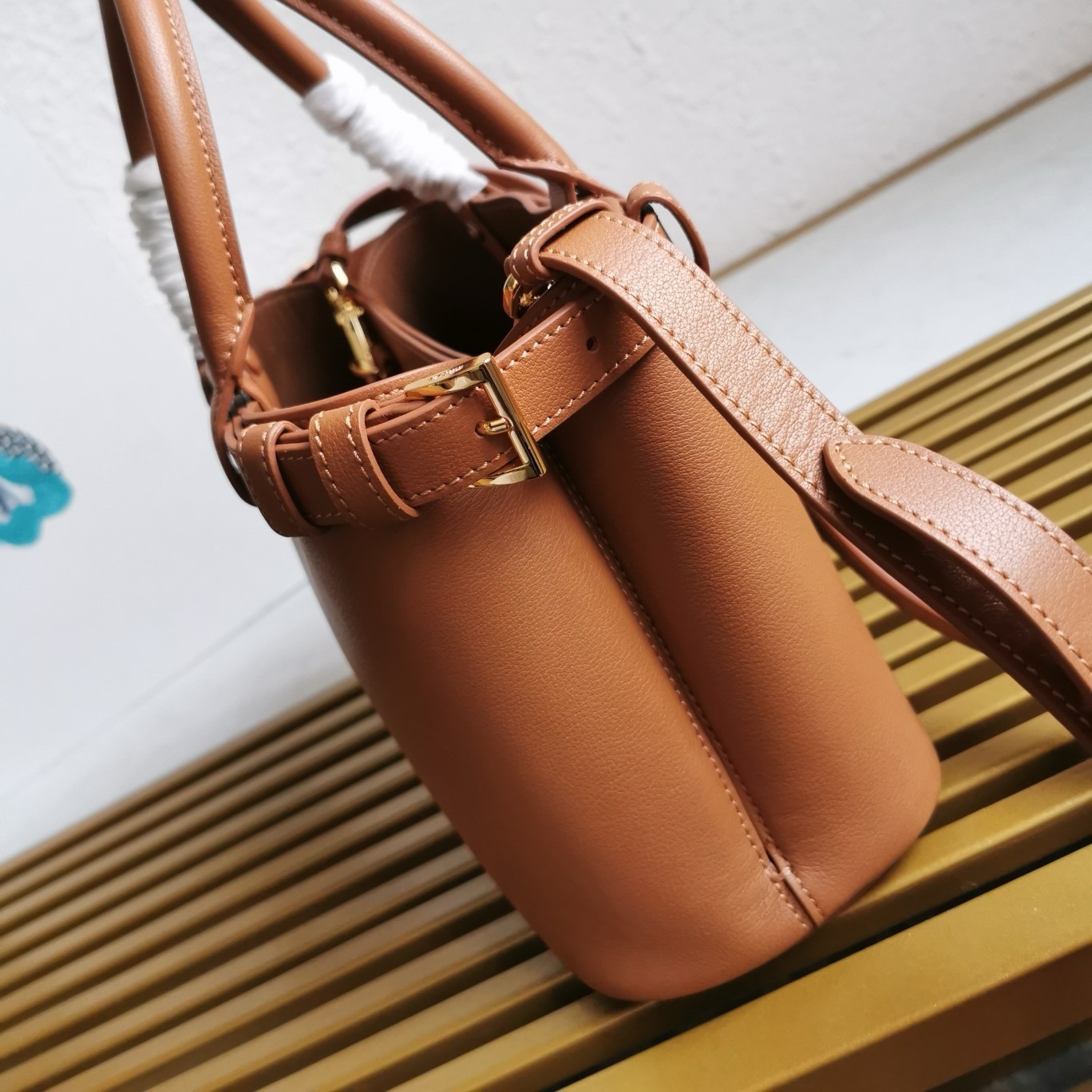 Pra*a buckle small bag with double belt in brown leather
