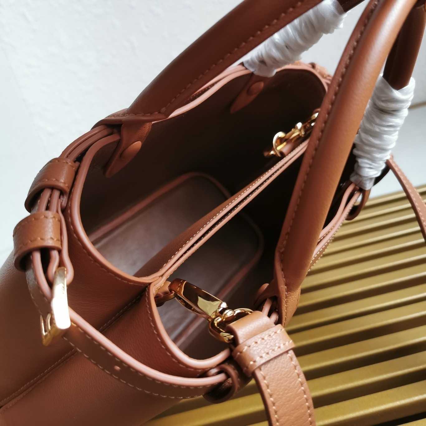 Pra*a buckle small bag with double belt in brown leather