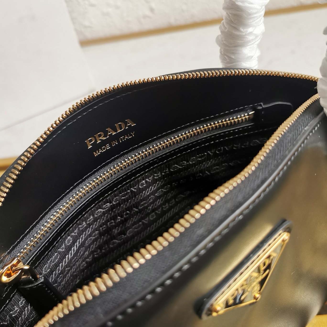 Pra*a shoulder bag with double zipper in black calfskin