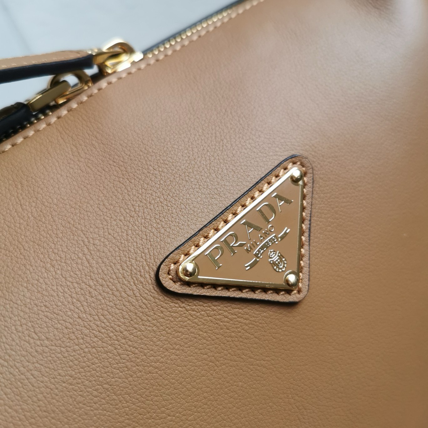 Pra*a shoulder bag in brown calfskin with triangle logo