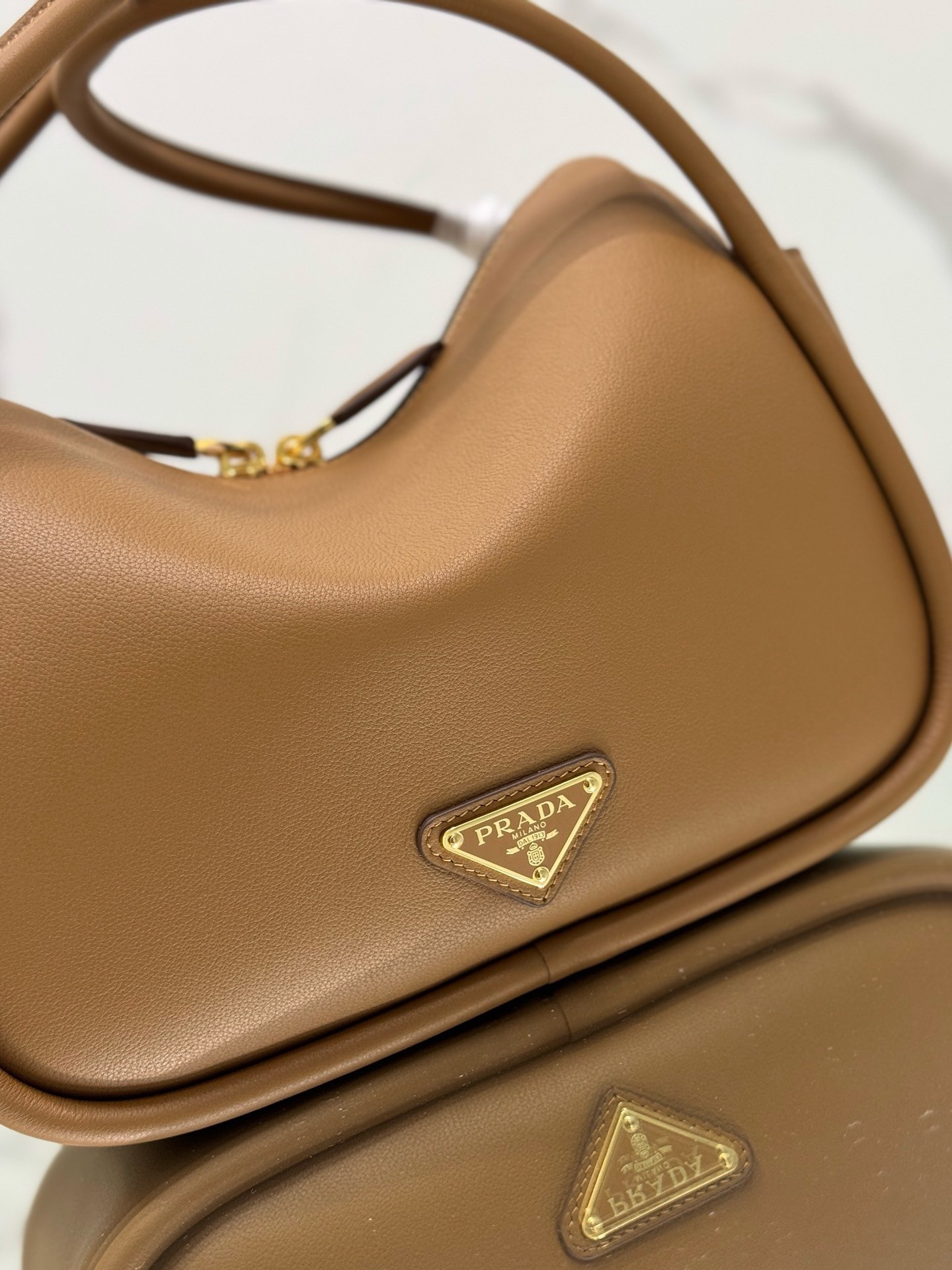 Pra*a top handle bag in caramel grained leather