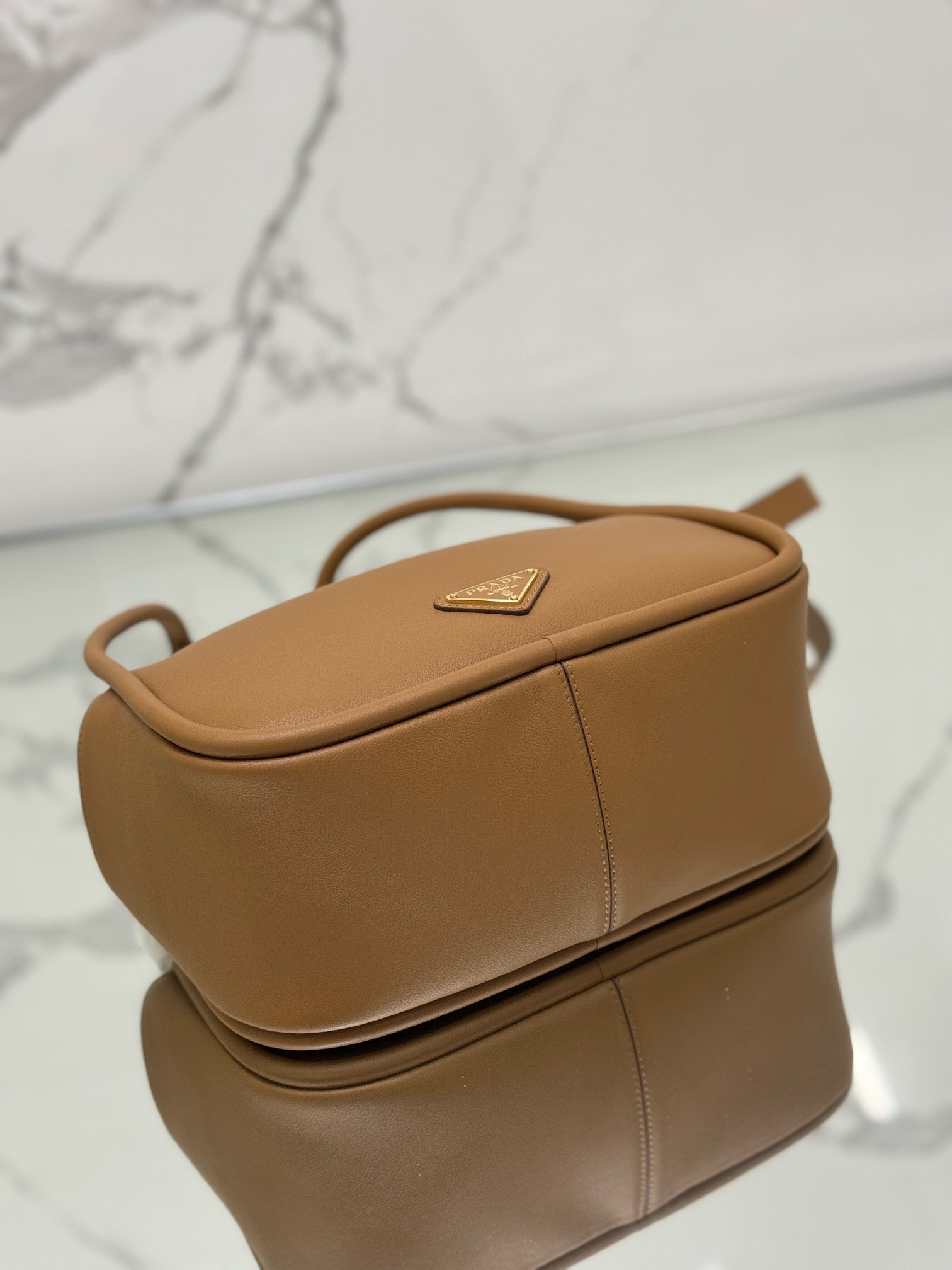 Pra*a top handle bag in caramel grained leather