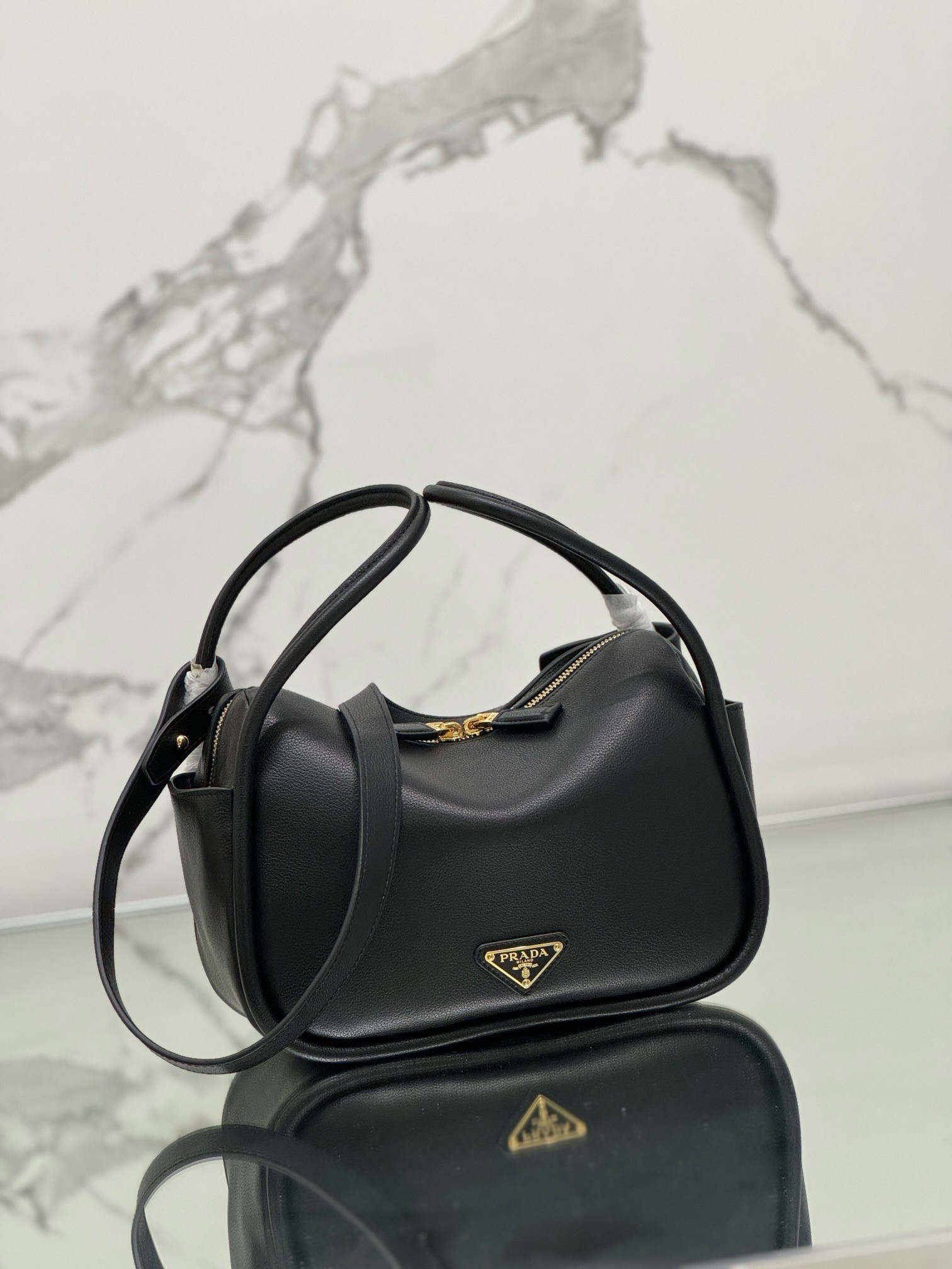 Pra*a top handle bag in black grained leather