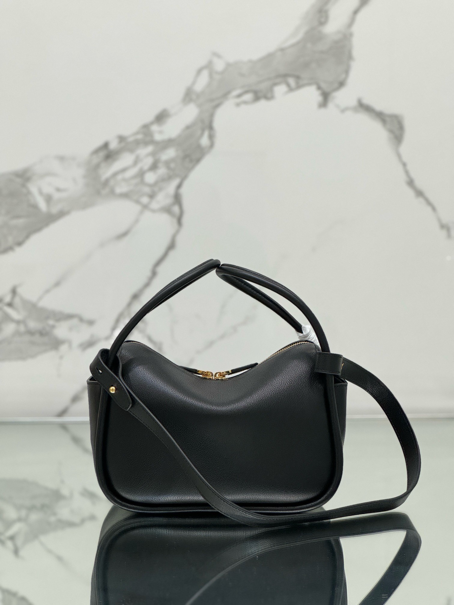 Pra*a top handle bag in black grained leather