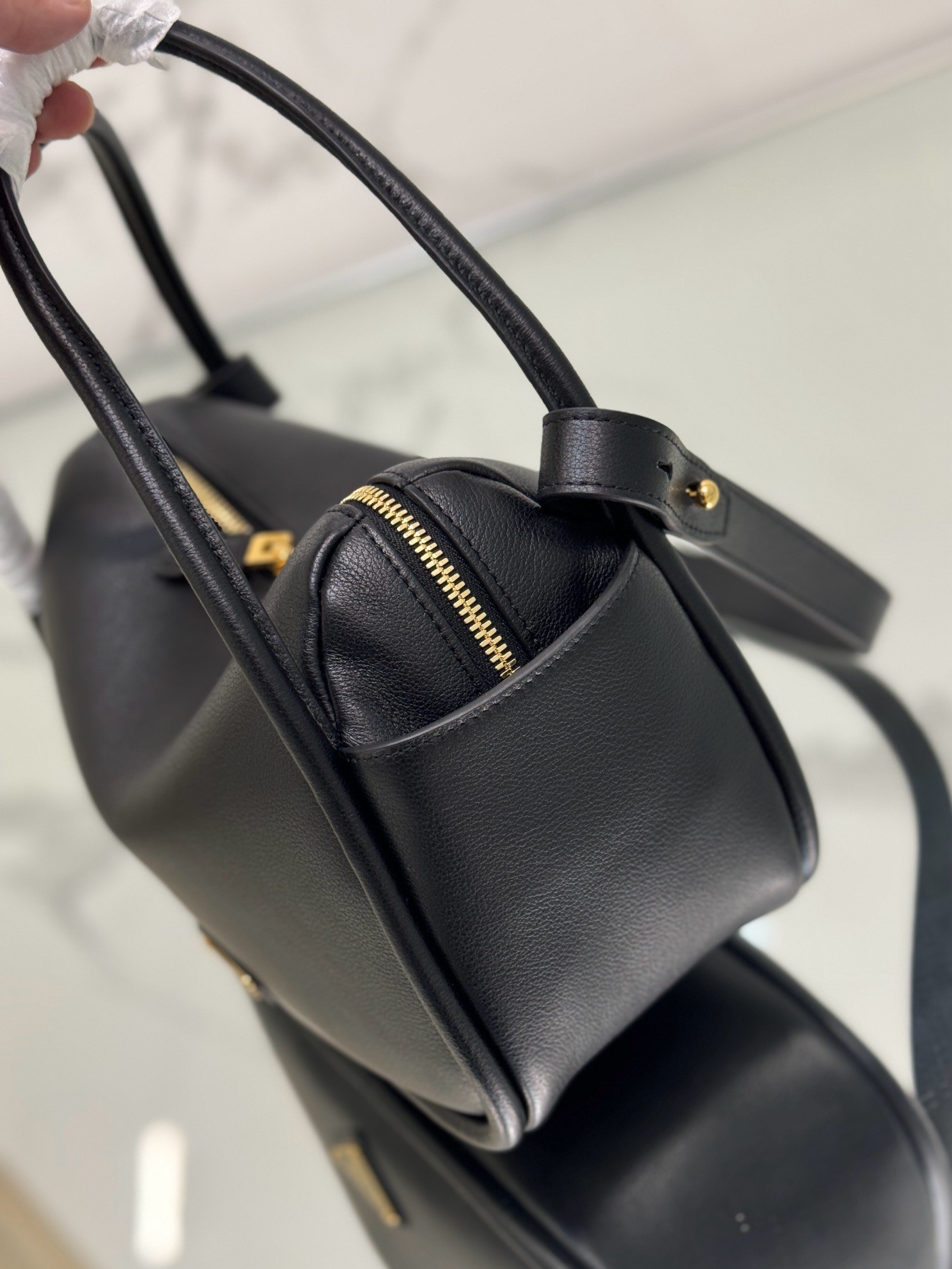 Pra*a top handle bag in black grained leather