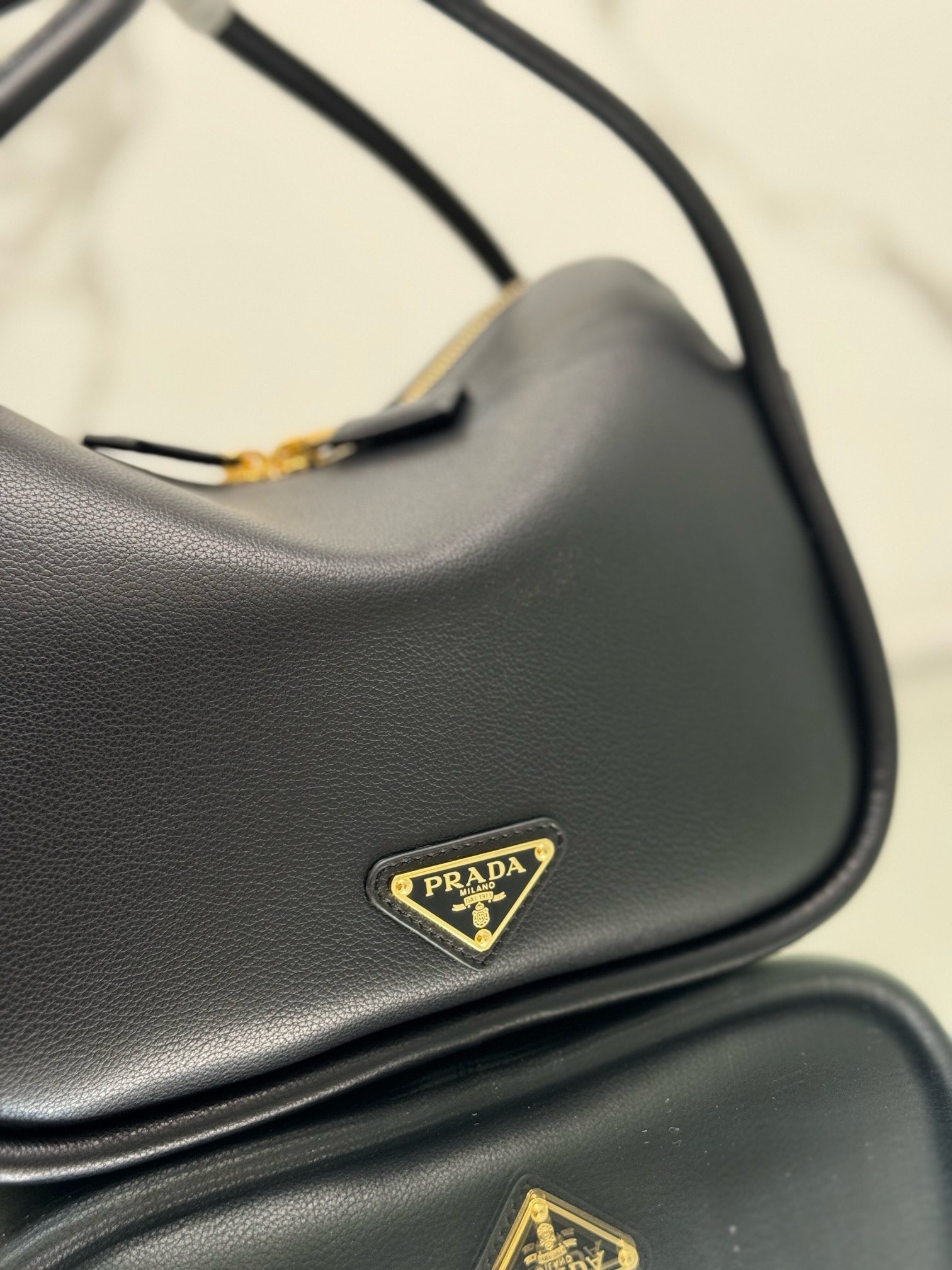 Pra*a top handle bag in black grained leather