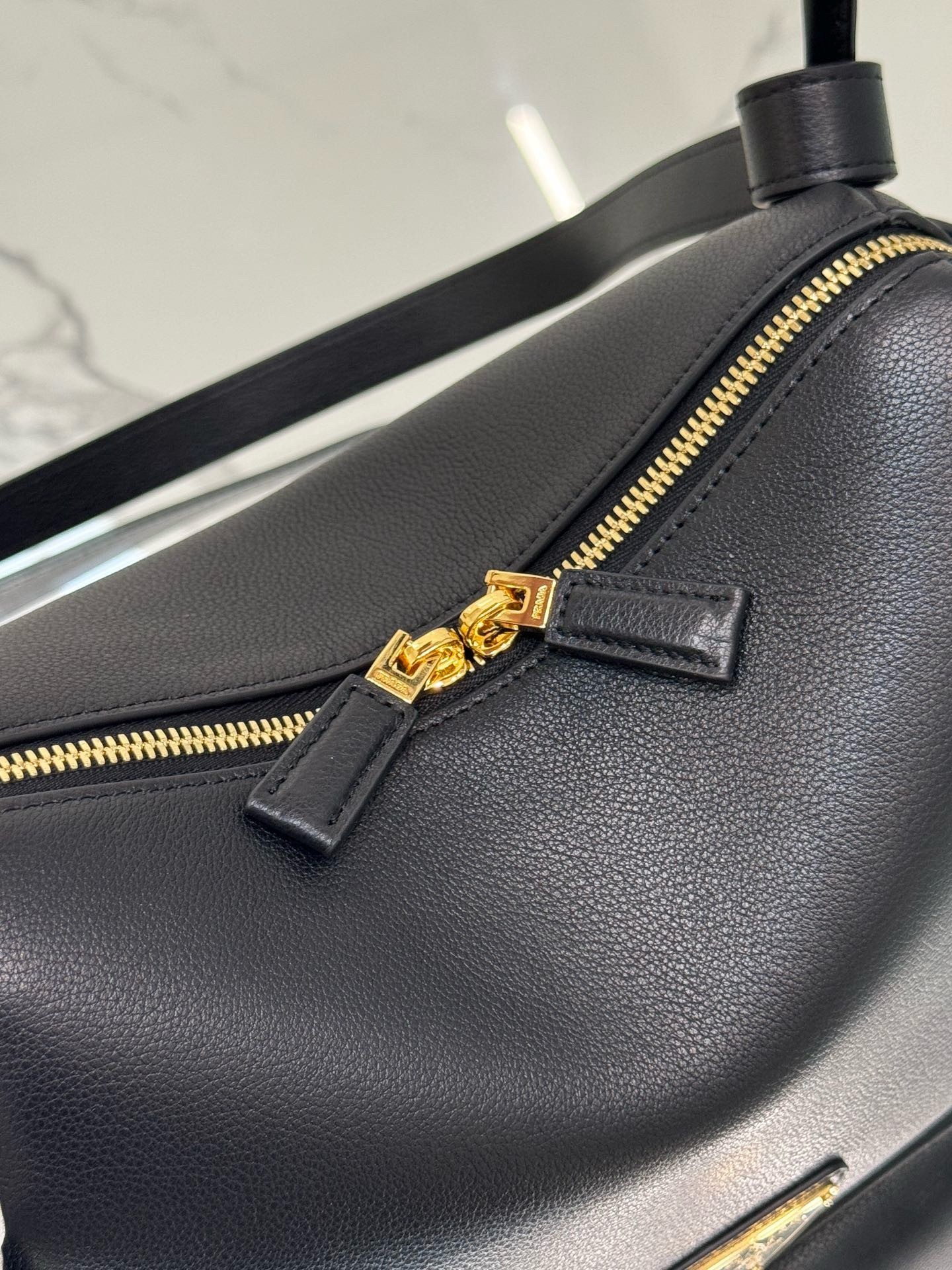 Pra*a top handle bag in black grained leather
