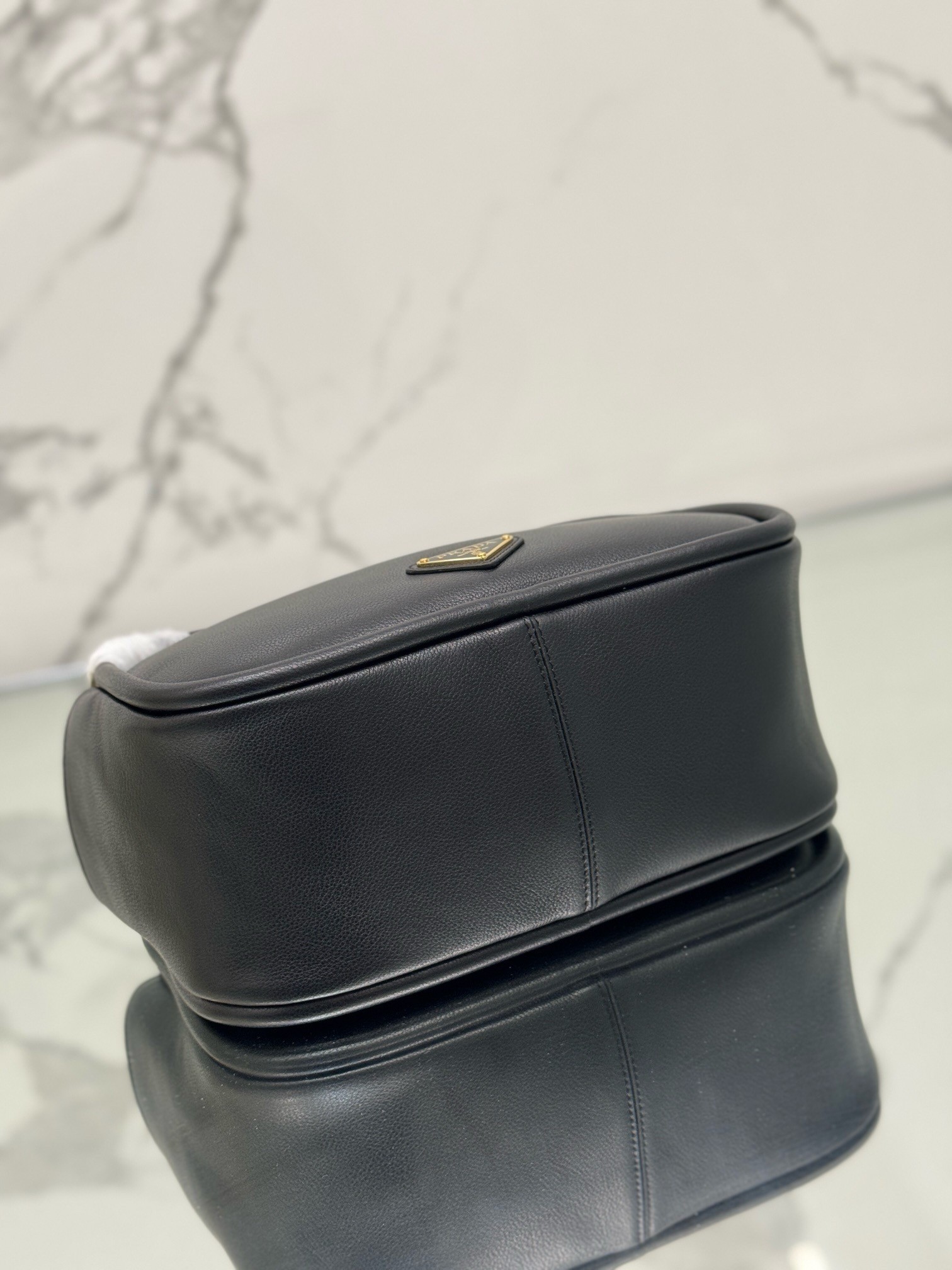 Pra*a top handle bag in black grained leather