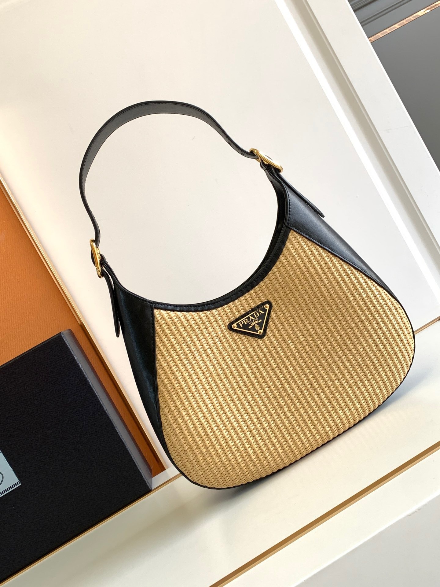 Pra*a shoulder bag in woven straw and black leather