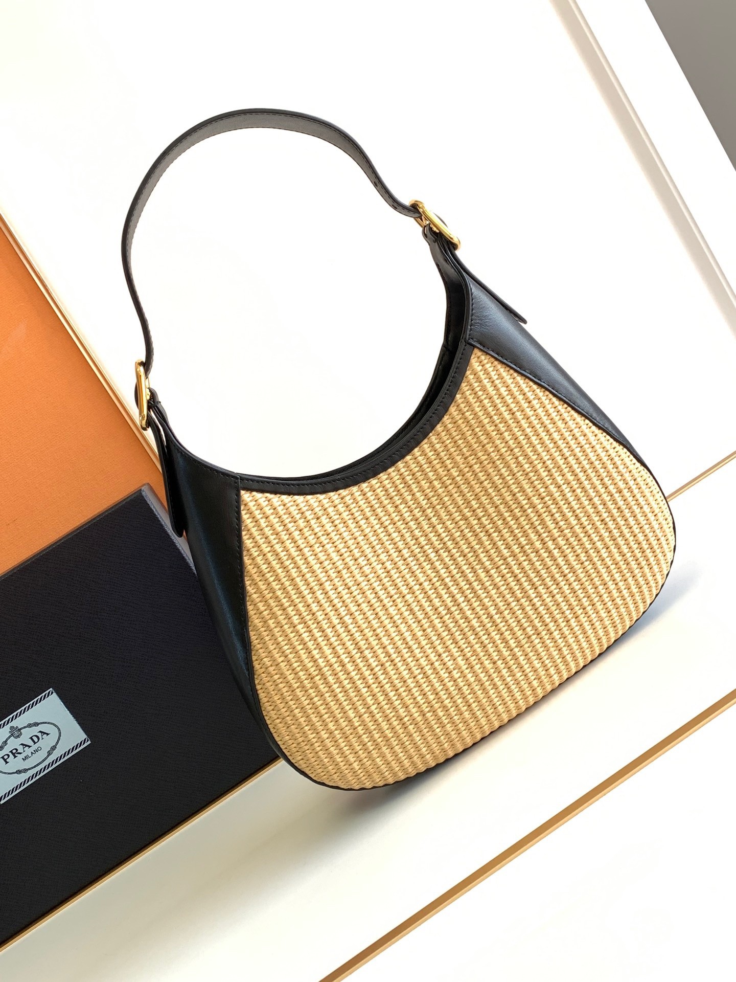 Pra*a shoulder bag in woven straw and black leather