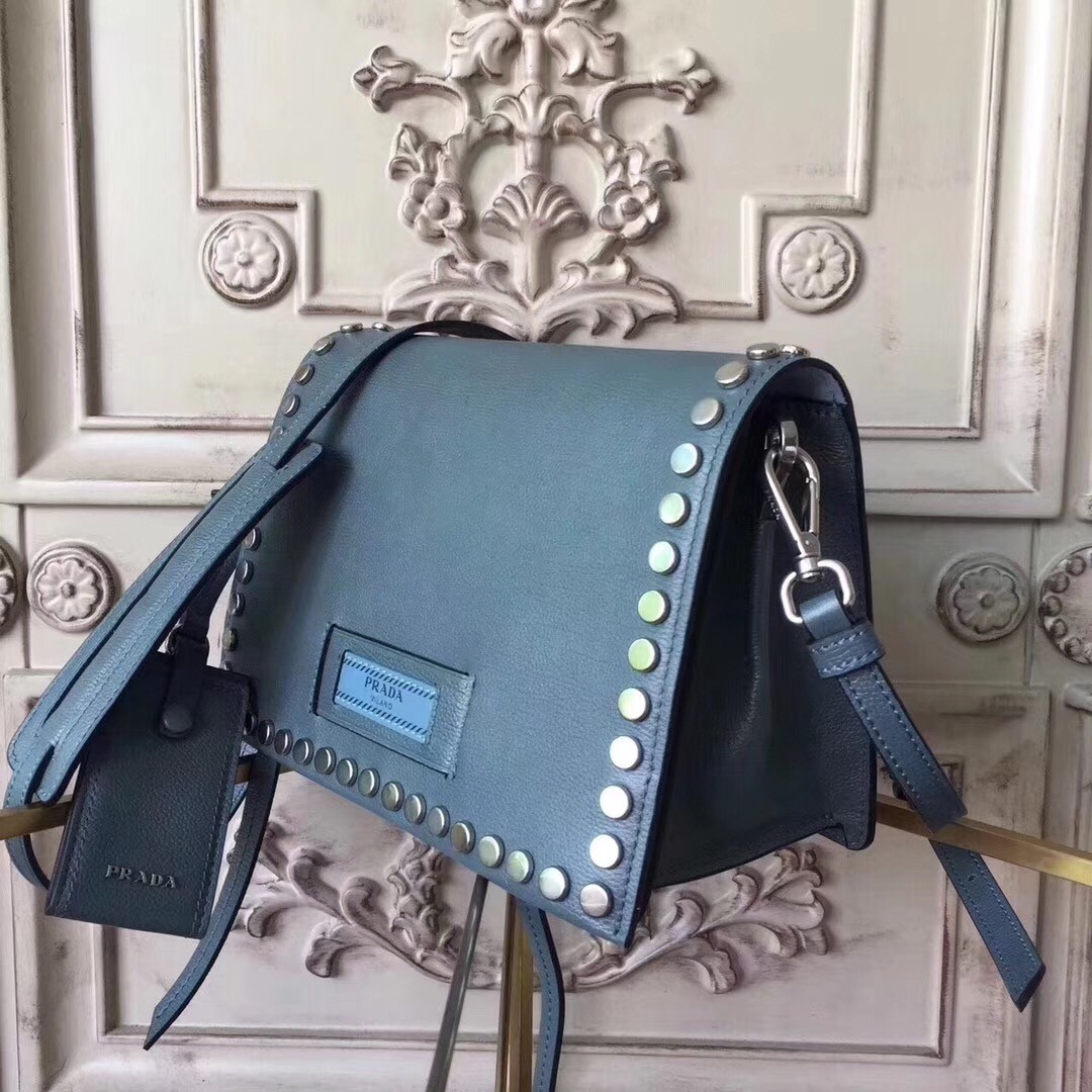 Pra*a etiquette bag in blue calfskin with metal stud trim