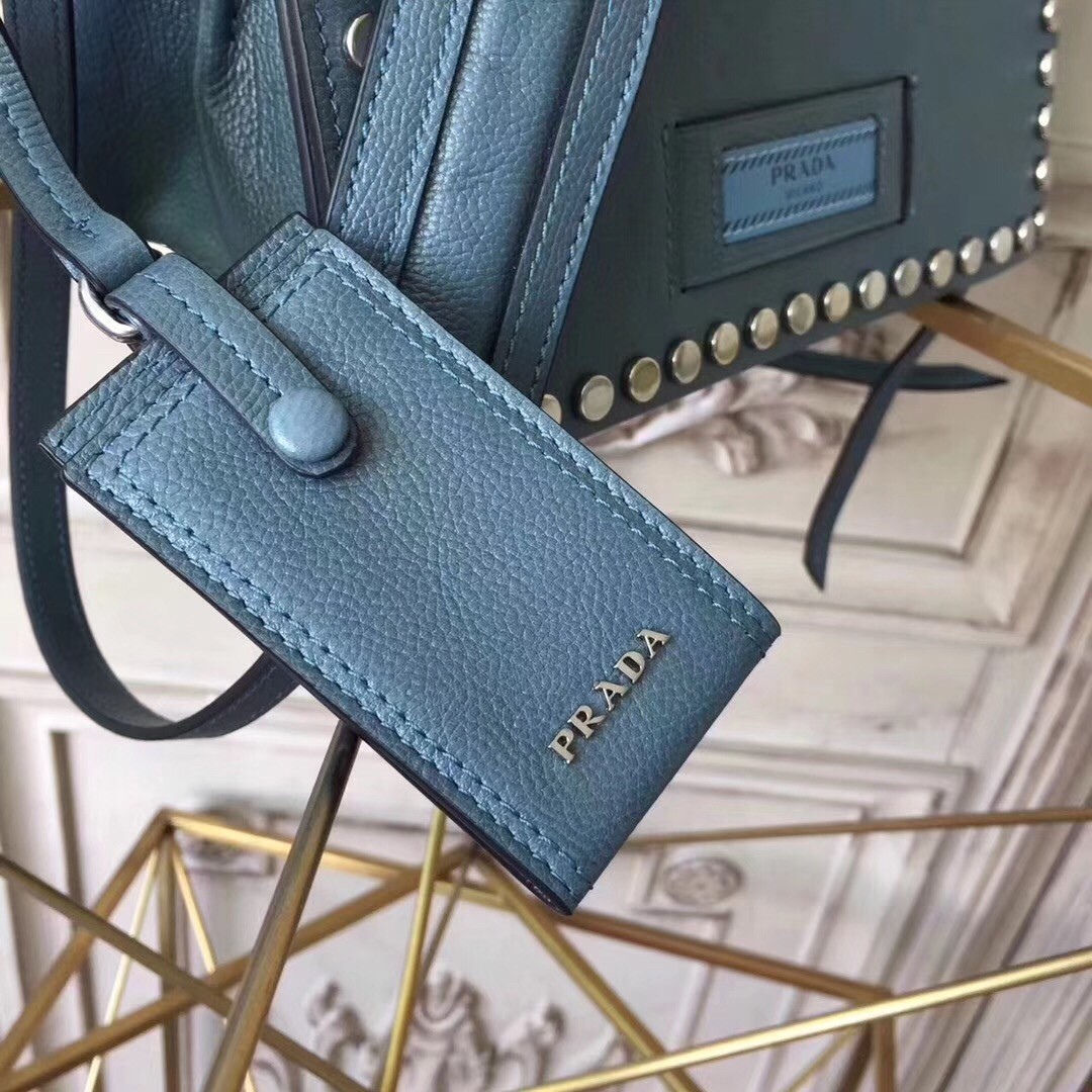 Pra*a etiquette bag in blue calfskin with metal stud trim