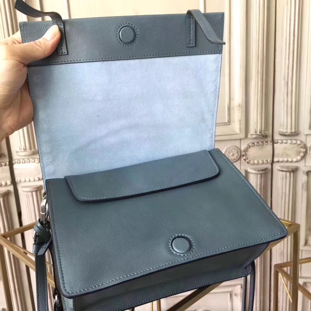 Pra*a etiquette bag in blue calfskin with metal stud trim