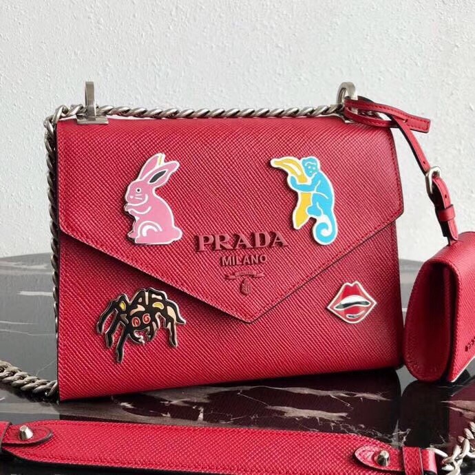 Pra*a red monochrome flap bag with metal appliques