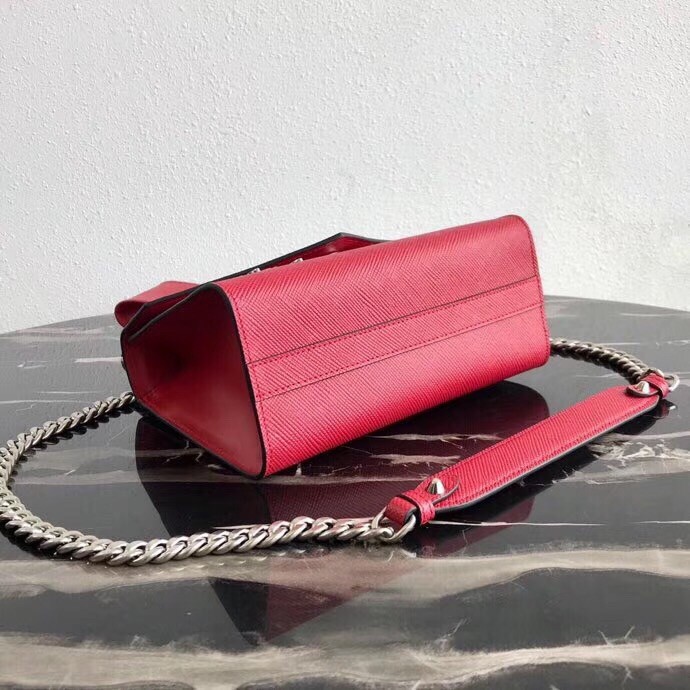 Pra*a red monochrome flap bag with metal appliques