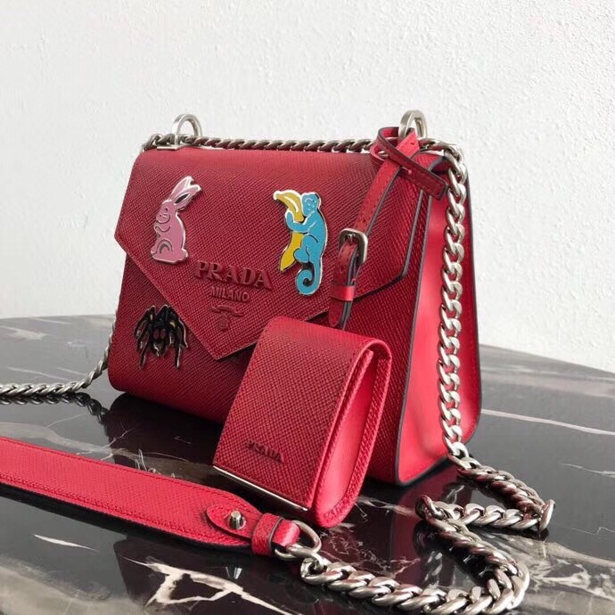 Pra*a red monochrome flap bag with metal appliques