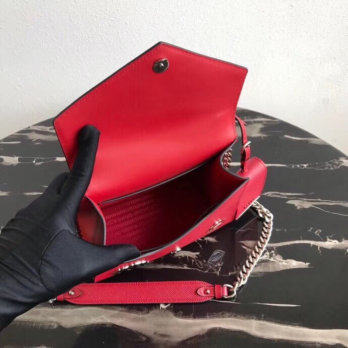 Pra*a red monochrome flap bag with metal appliques