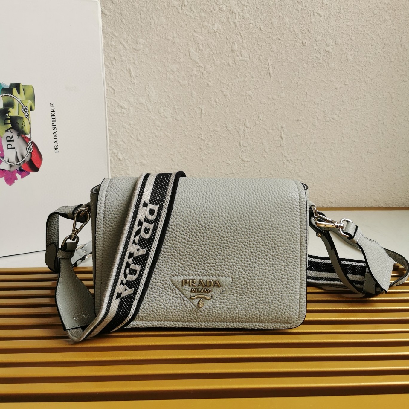 Pra*a flap shoulder bag in cornflower grained leather