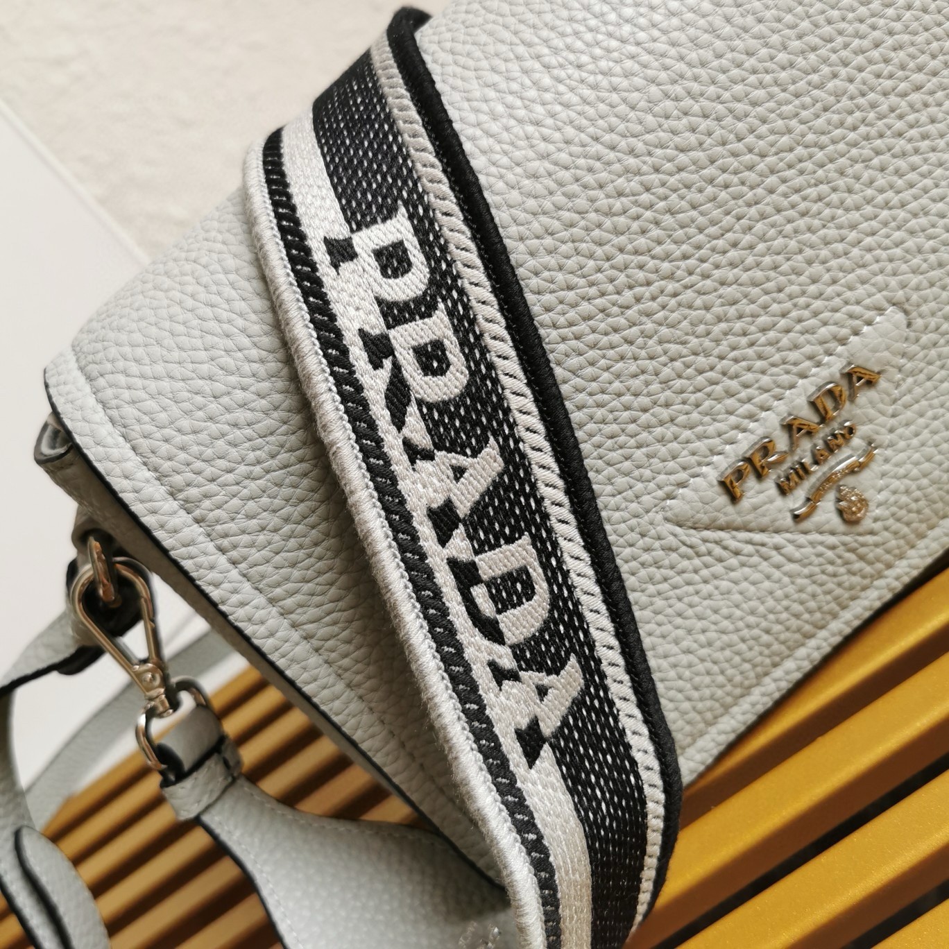 Pra*a flap shoulder bag in cornflower grained leather