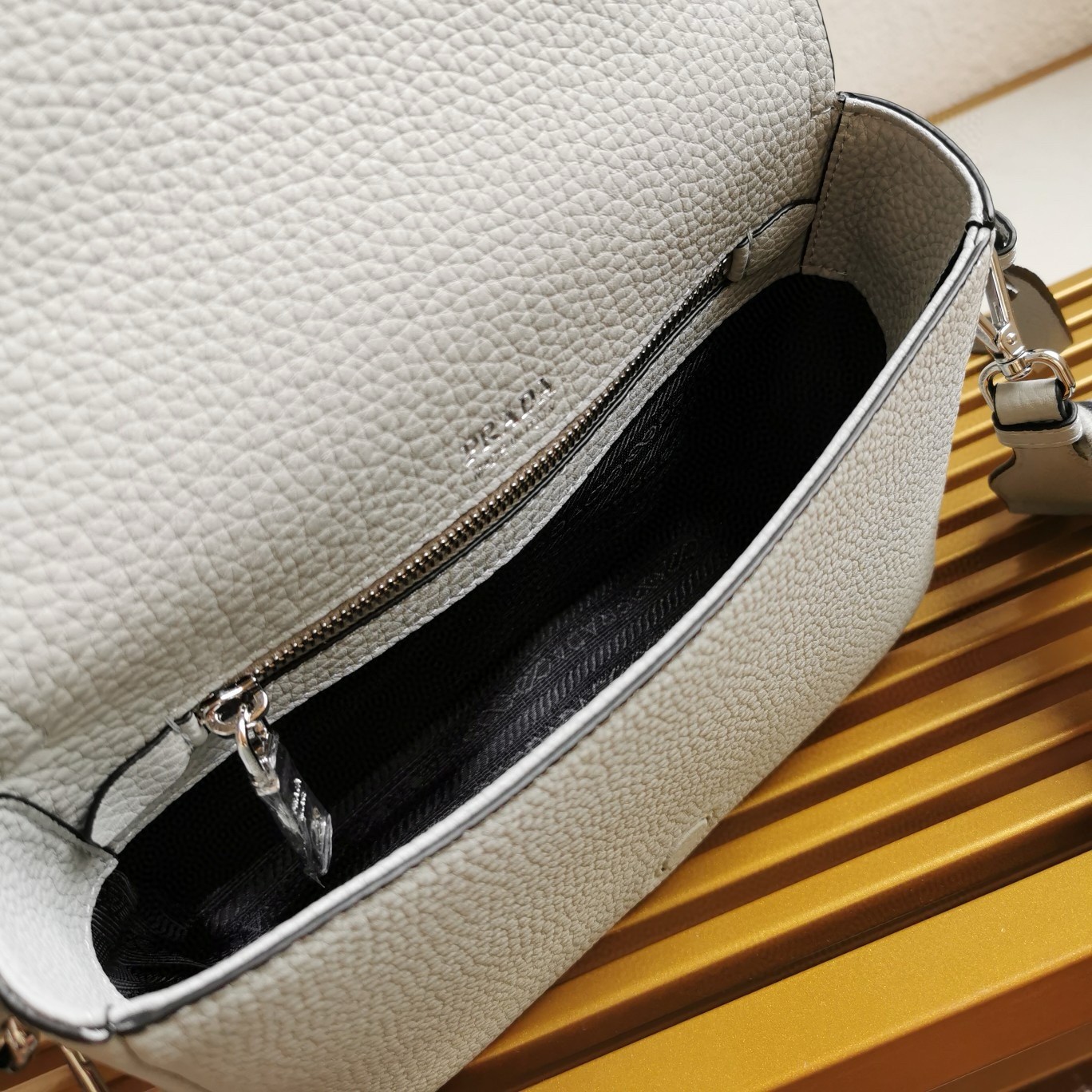 Pra*a flap shoulder bag in cornflower grained leather