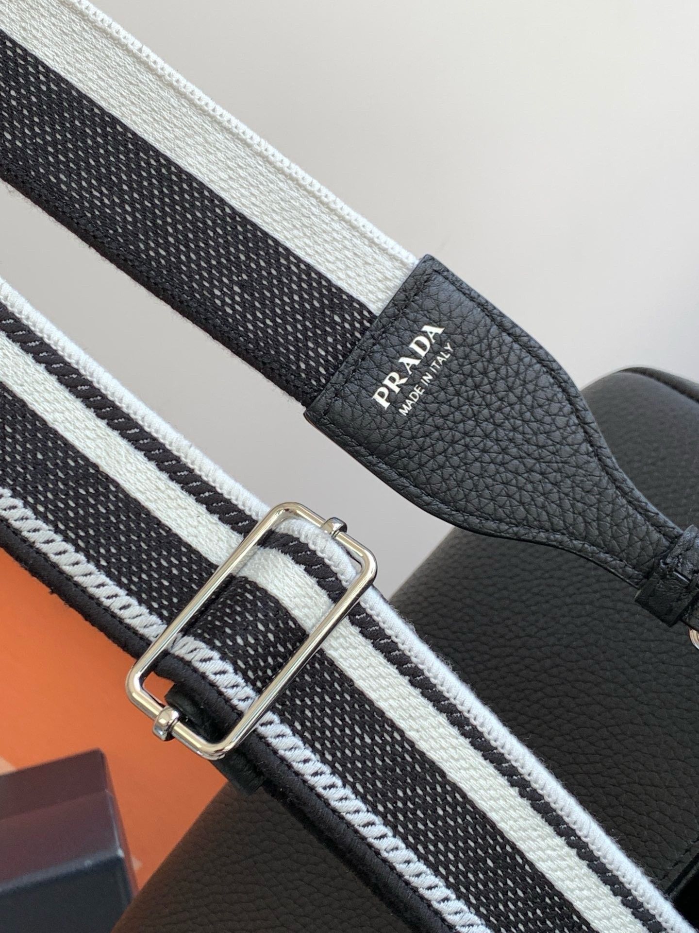 Pra*a flap shoulder bag in black grained leather