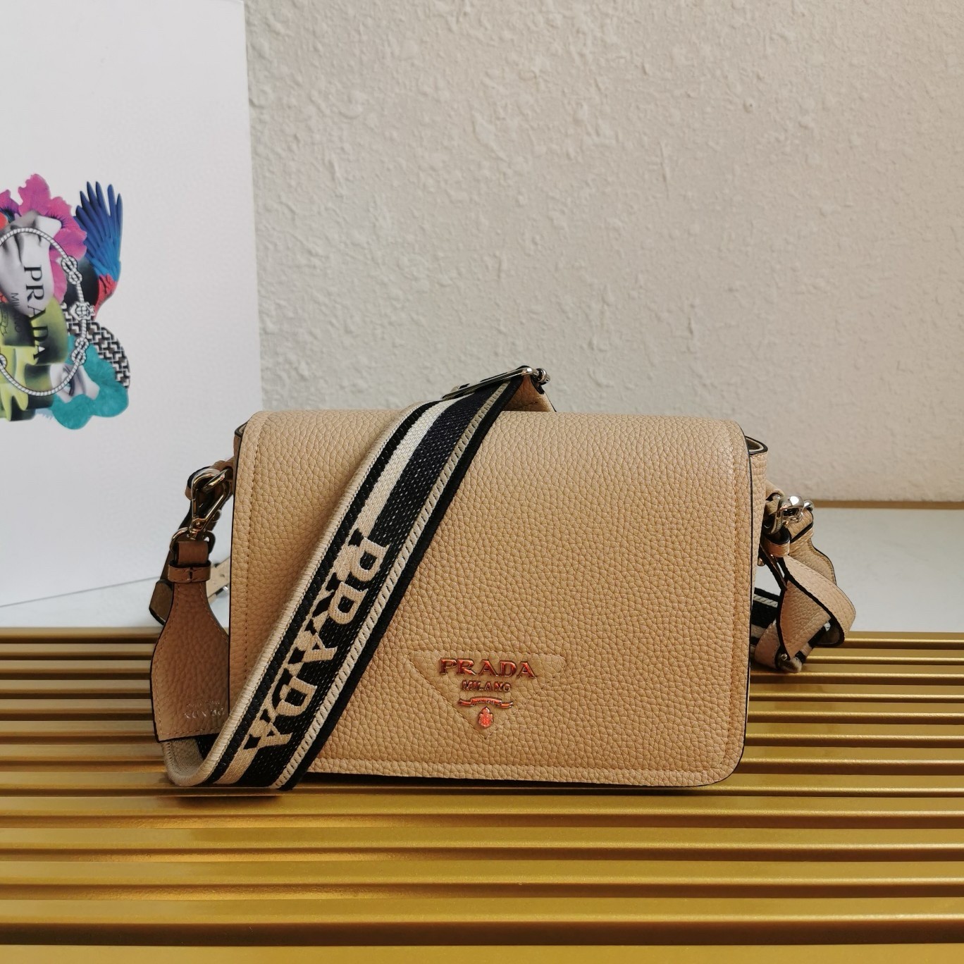 Pra*a flap shoulder bag in sand grained leather