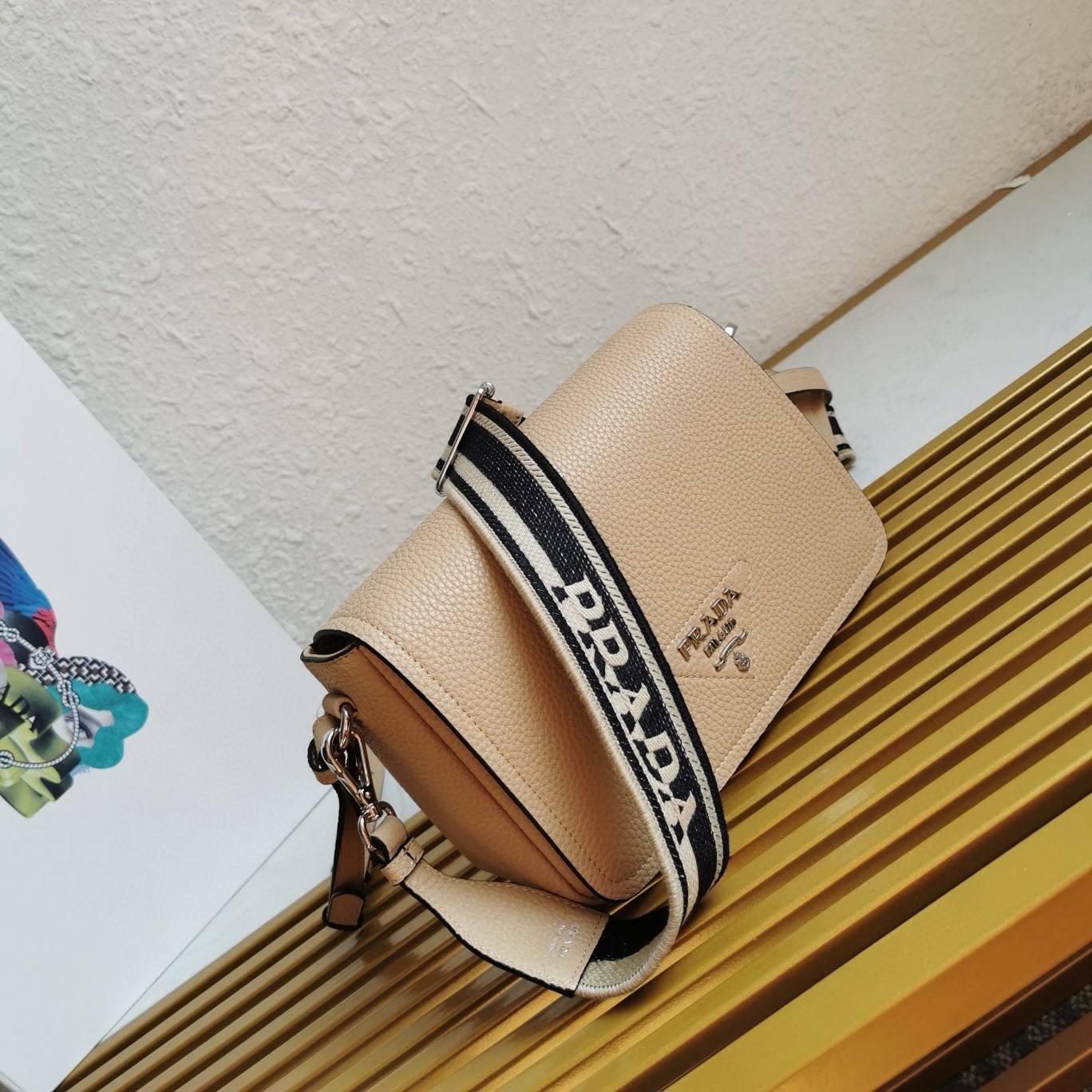 Pra*a flap shoulder bag in sand grained leather