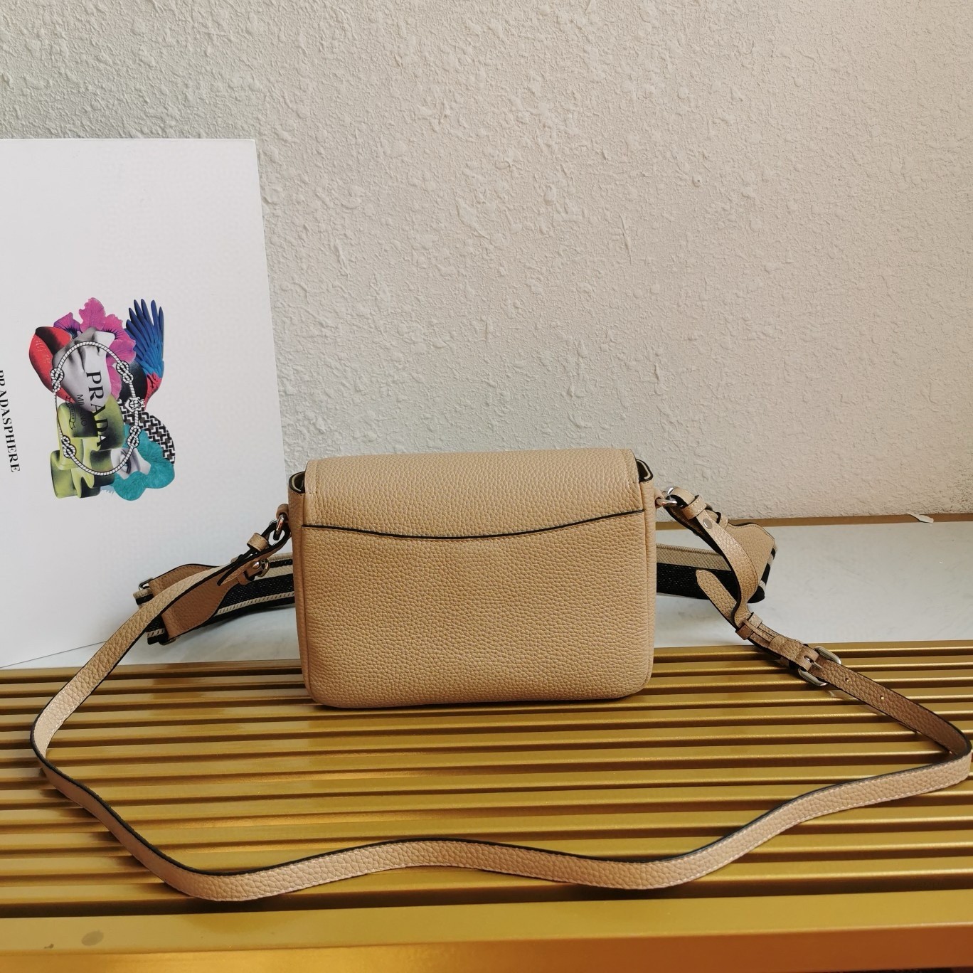 Pra*a flap shoulder bag in sand grained leather