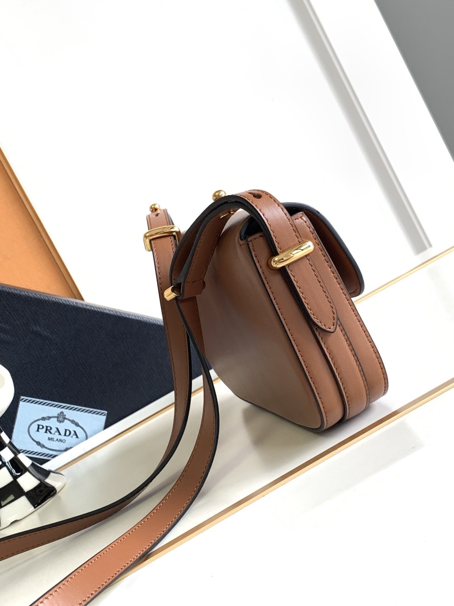 Pra*a shoulder bag in cognac smooth calfskin