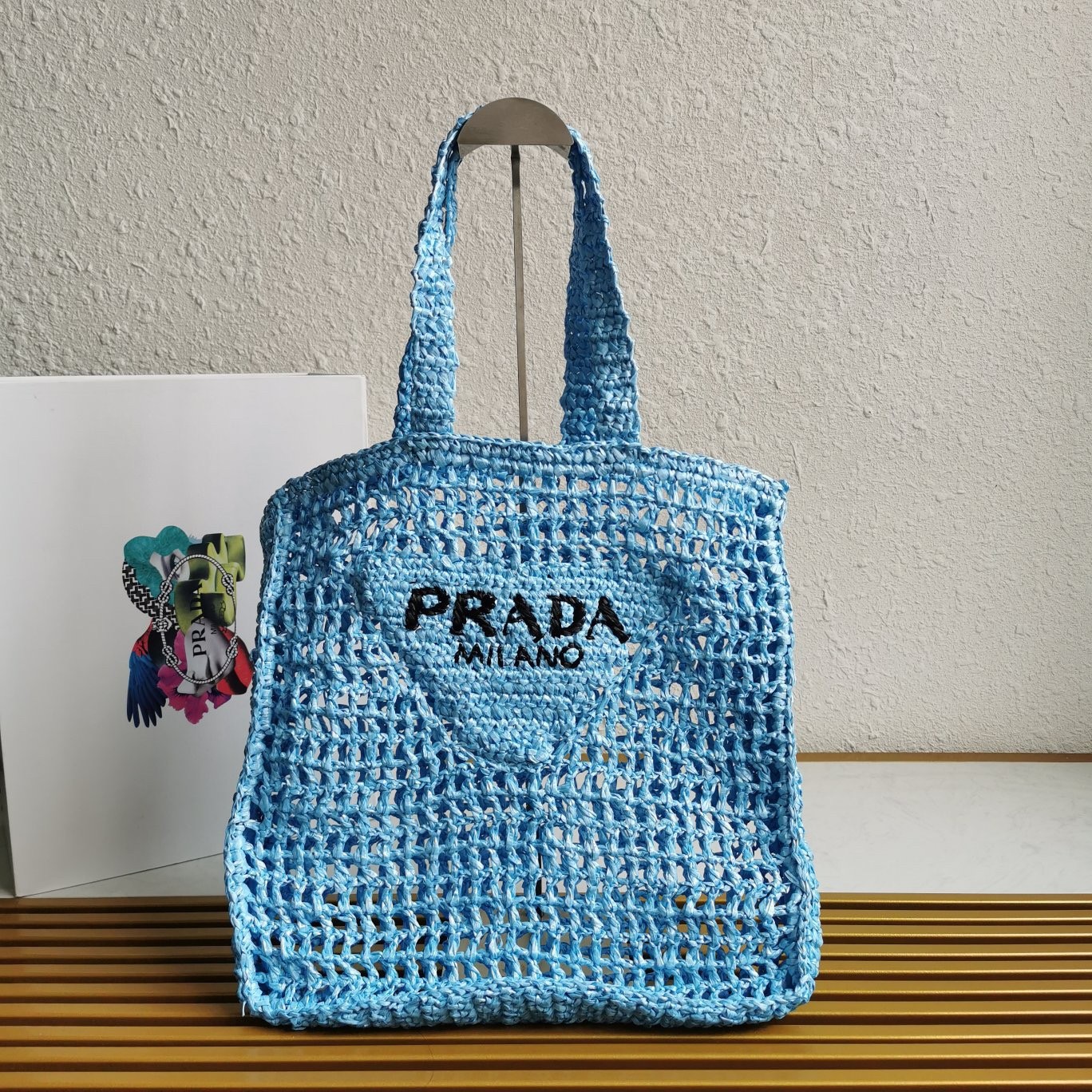 Pra*a small tote bag in blue woven raffia