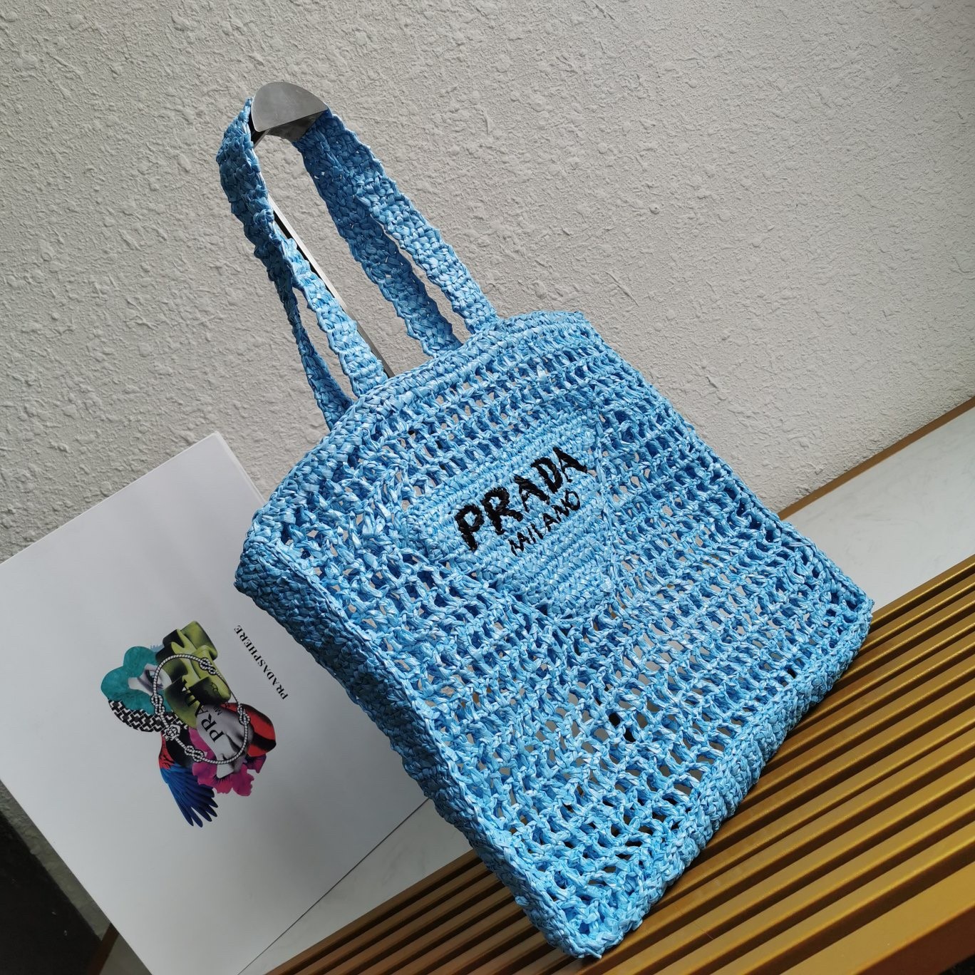 Pra*a small tote bag in blue woven raffia