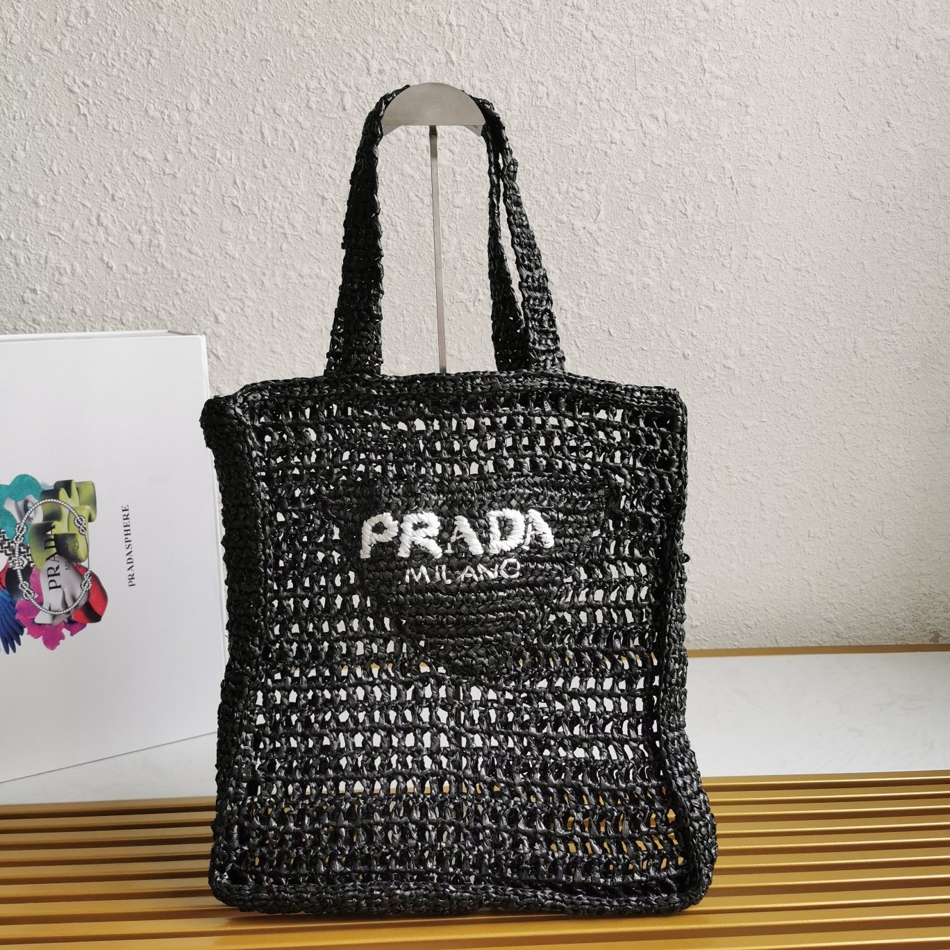 Pra*a small tote bag in black woven raffia