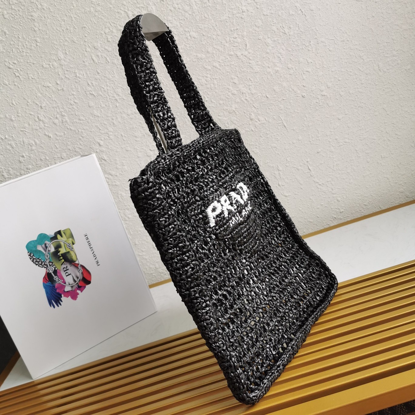 Pra*a small tote bag in black woven raffia