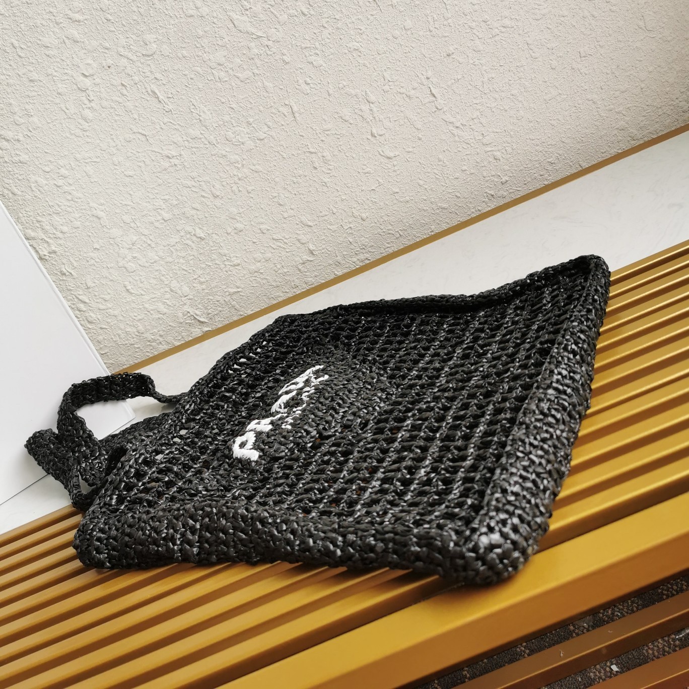 Pra*a small tote bag in black woven raffia