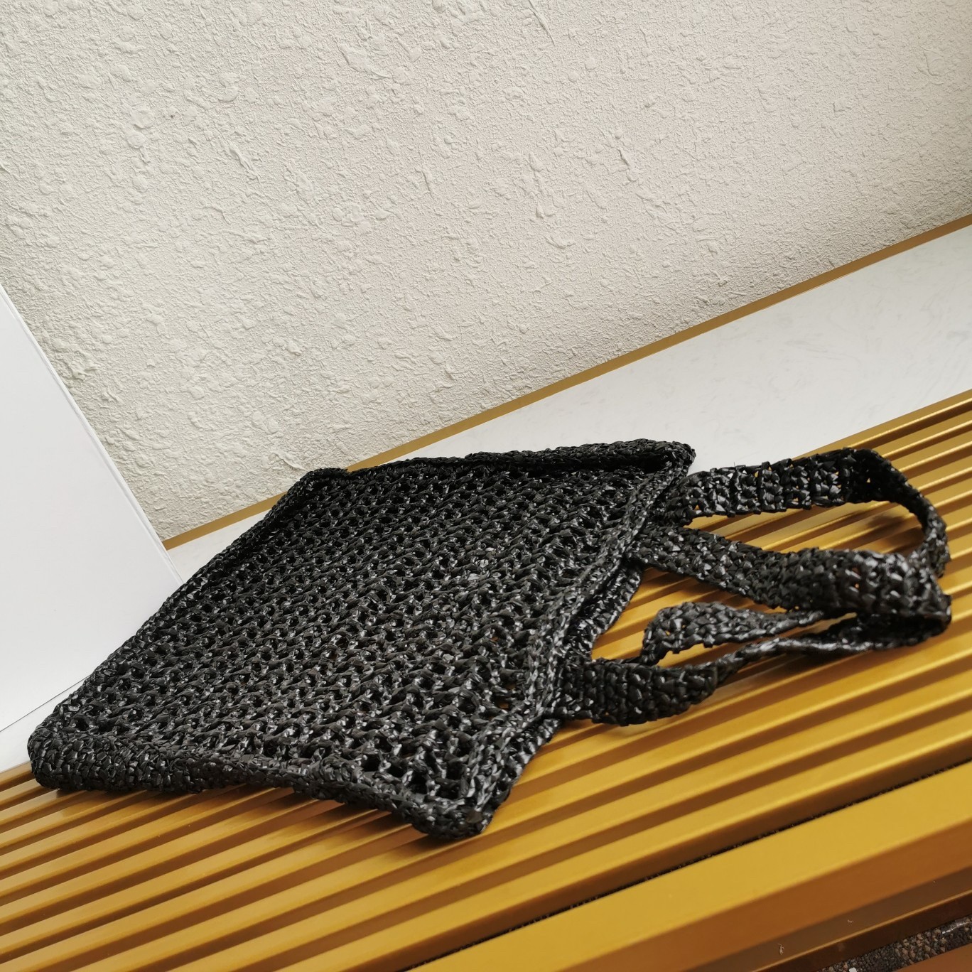 Pra*a small tote bag in black woven raffia