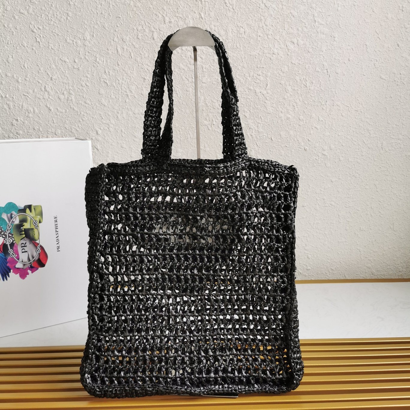 Pra*a small tote bag in black woven raffia