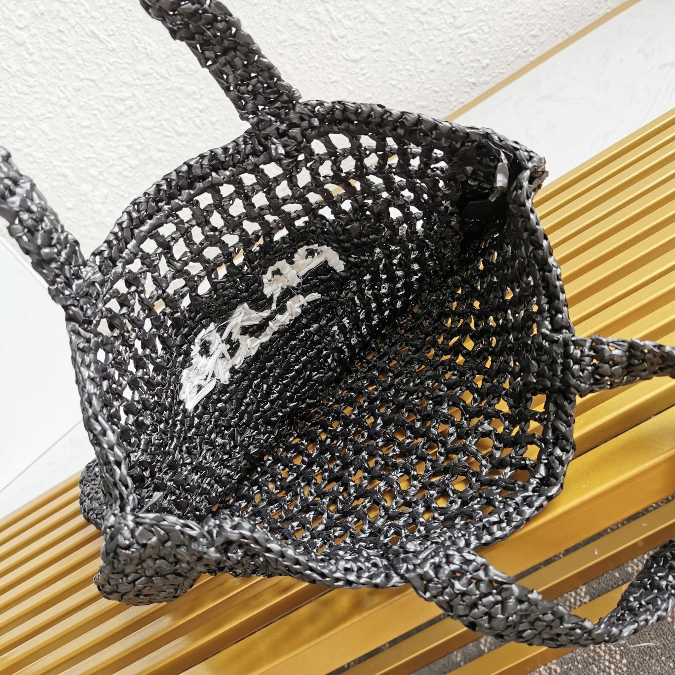 Pra*a small tote bag in black woven raffia
