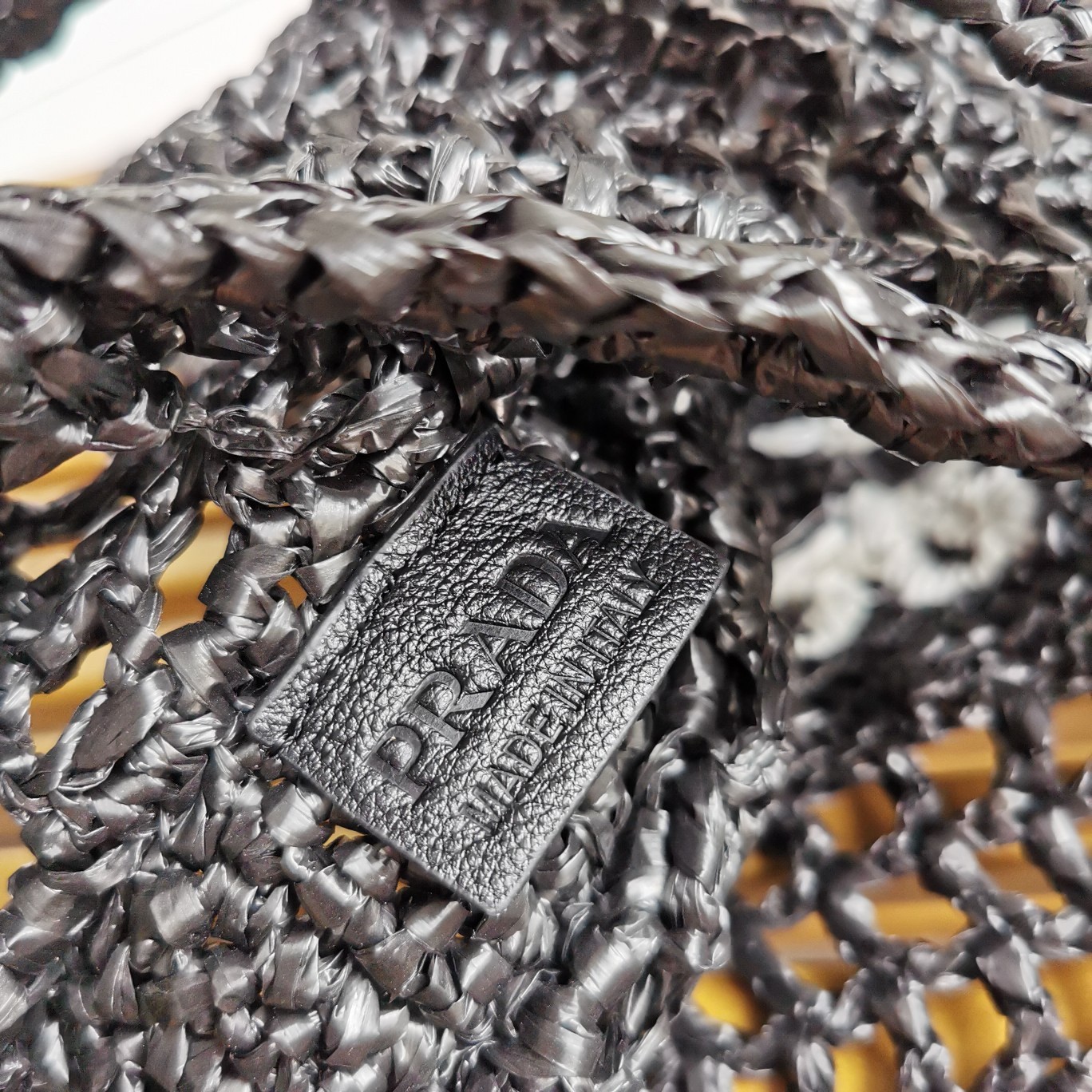 Pra*a small tote bag in black woven raffia