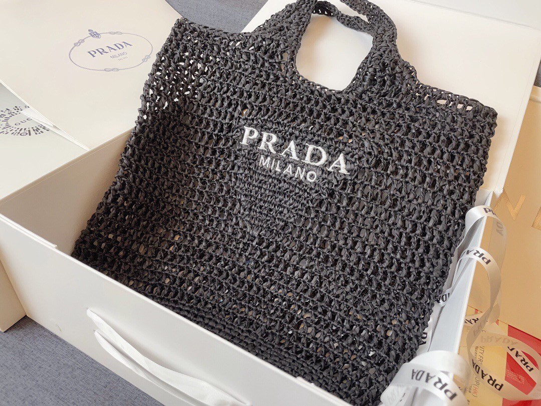 Pra*a large tote bag in black woven raffia