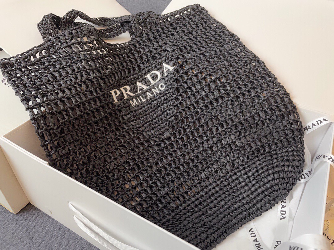 Pra*a large tote bag in black woven raffia