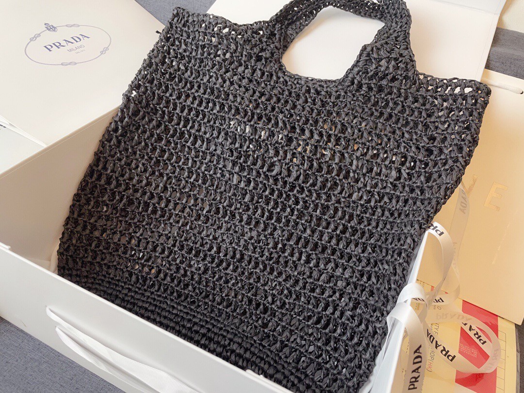 Pra*a large tote bag in black woven raffia